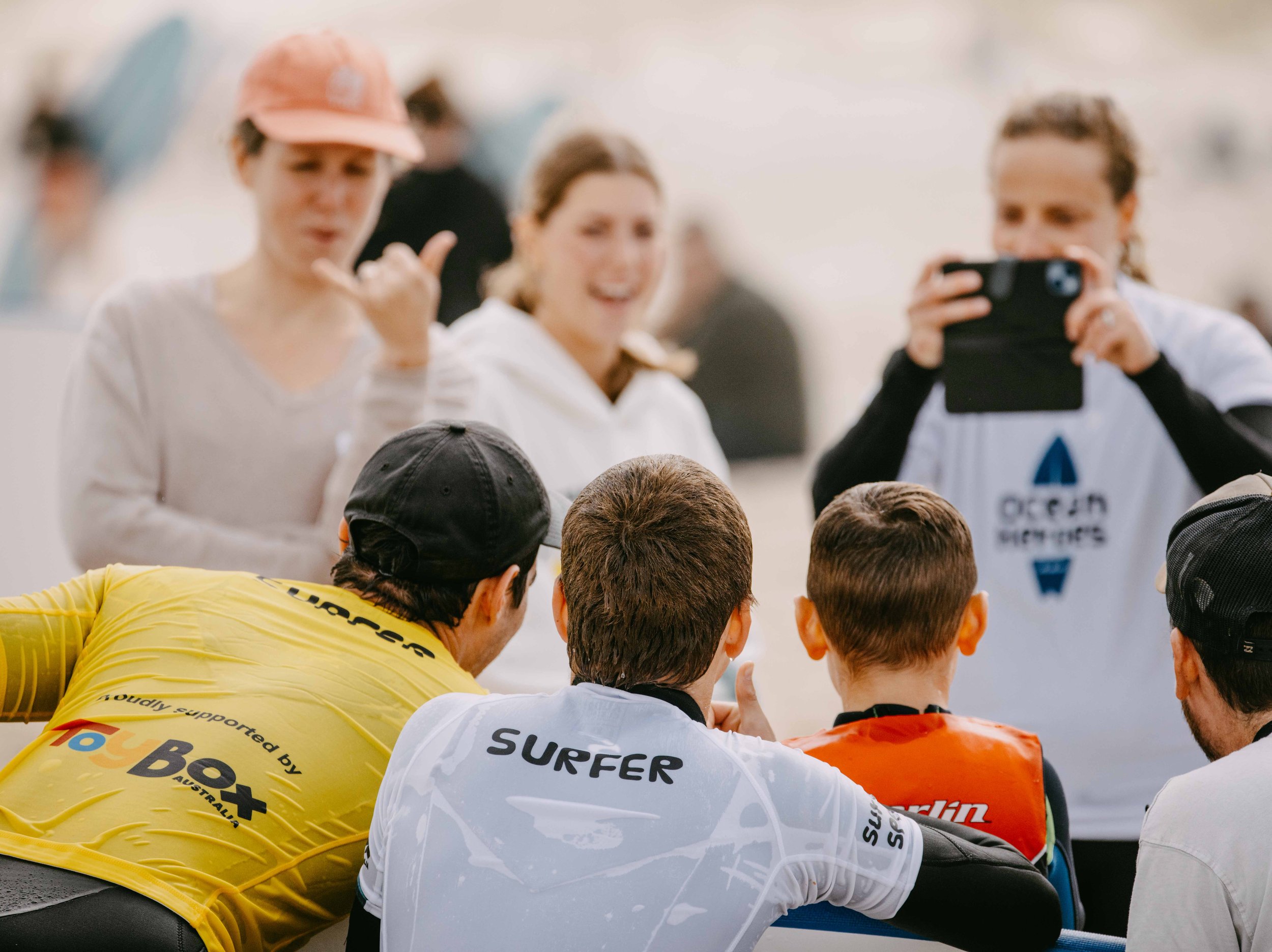 a group of surfers posing for photo