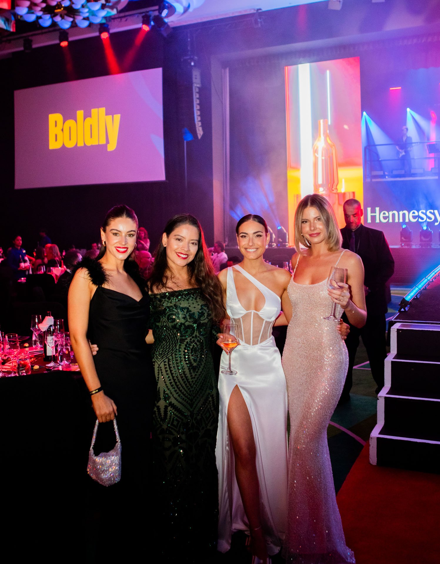 4 women in ball gowns at event