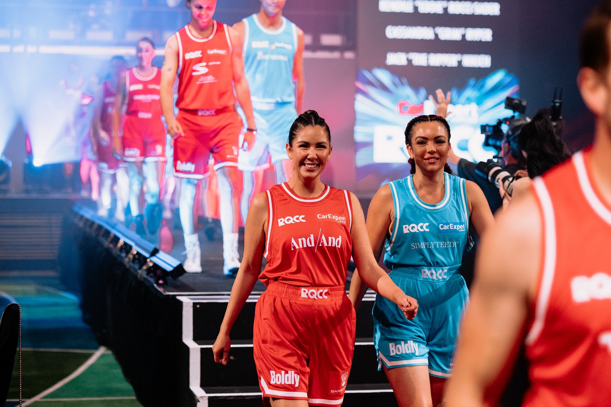 red and blue boxers entering the ring