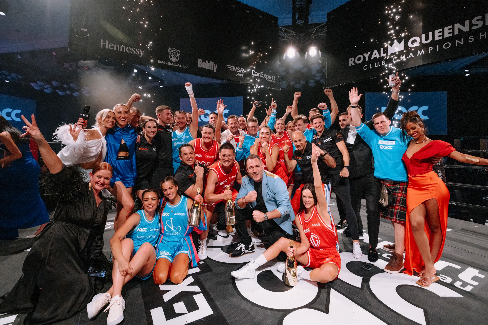 people celebrating in a boxing ring