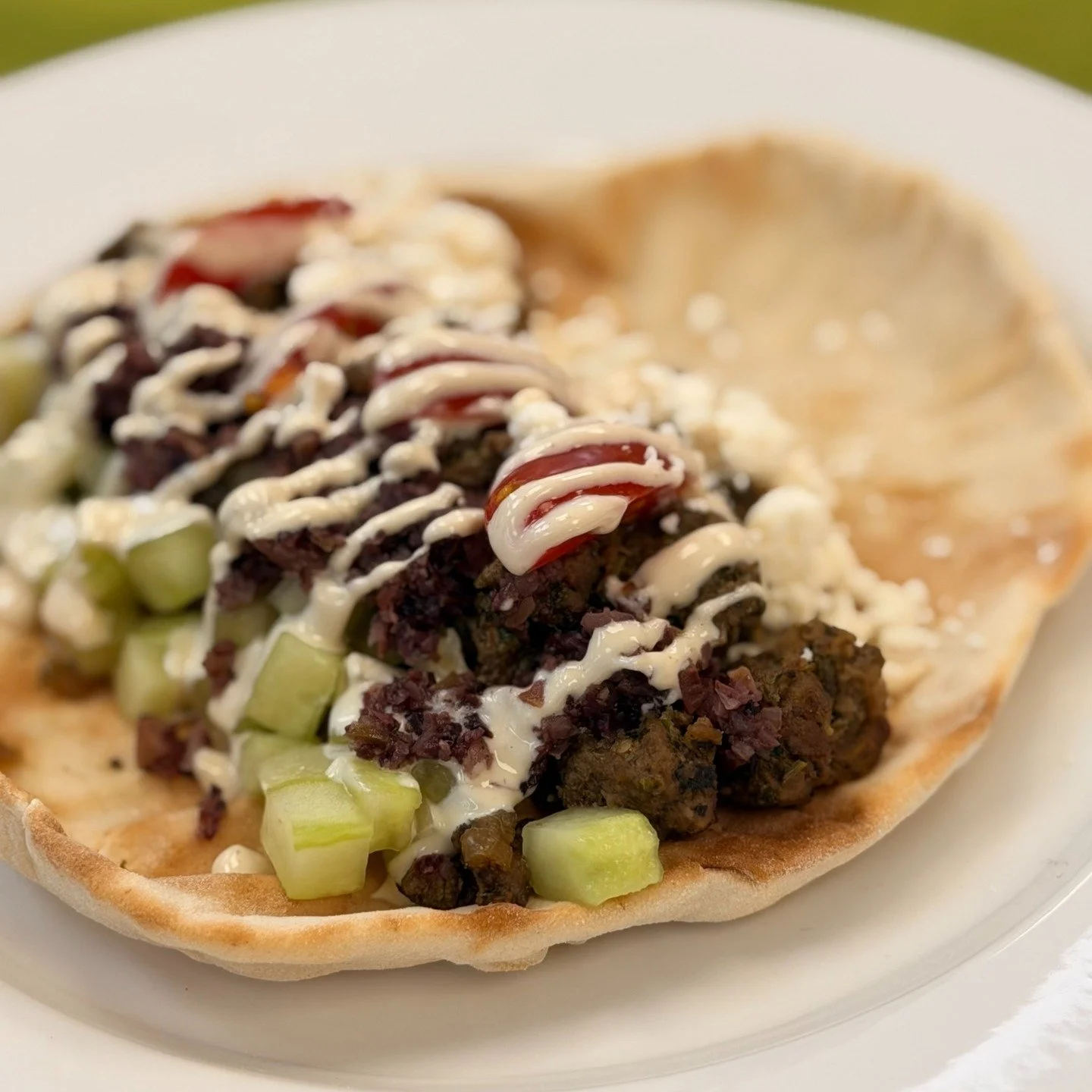 🥙 New flavor-packed addition to the Menu: Middle Eastern Pita Sandwich!

This pita sandwich, inspired by one of our Jordanian culinary training alum, features ground lamb, tahini yogurt, cucumber, tomato, Kalamata olive tapenade, and feta cheese on 