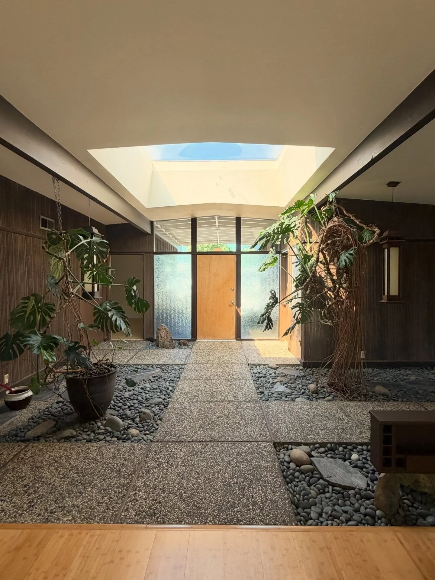 The atrium: bringing the outside in ✨ 

Listed at $610,000 - a masterclass in organic modernism. 

Comment &ldquo;plants&rdquo; for the listing in your inbox! 

Listing courtesy of Steve Streng