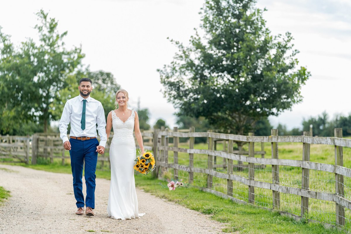 bride and groom portrait walking at dodford manor. 
