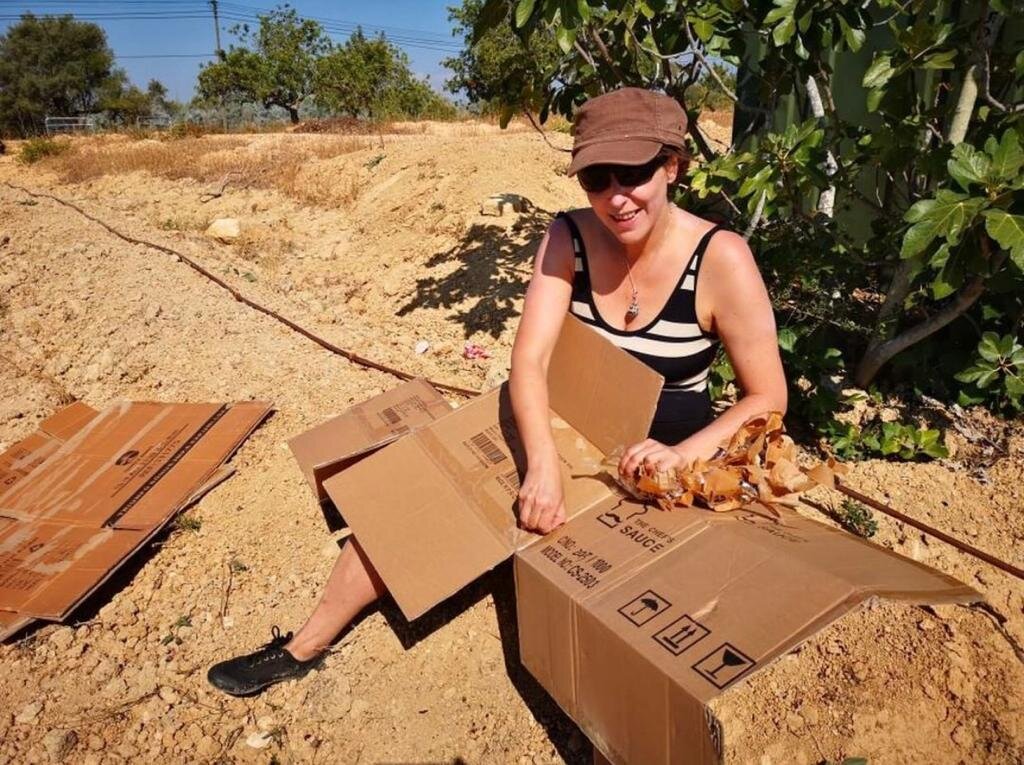 wwoofer from France mulching with cardboard