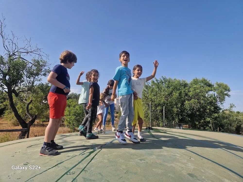 Kids_jumping_on_flexible_water_tank.jpg