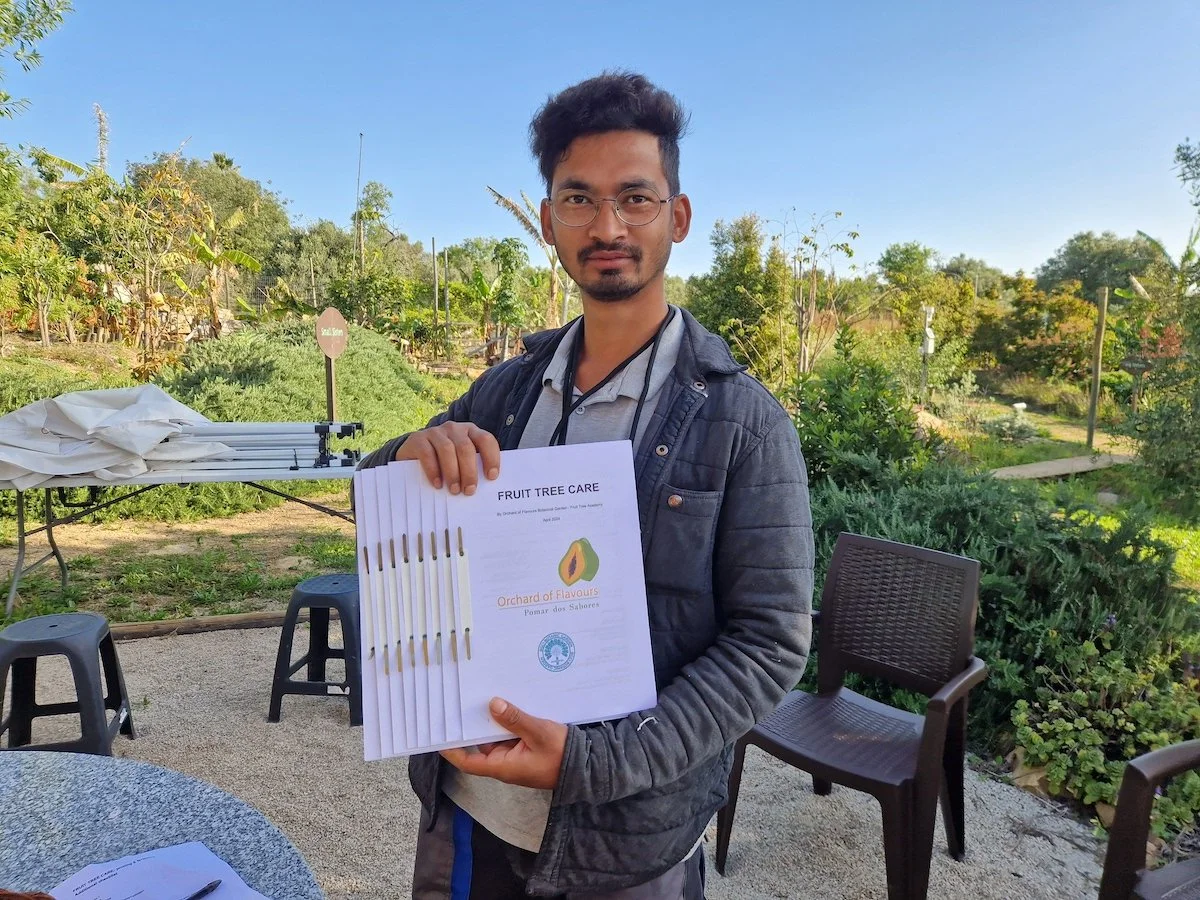 Milan Nepali the garden manager holding Workshop manuals