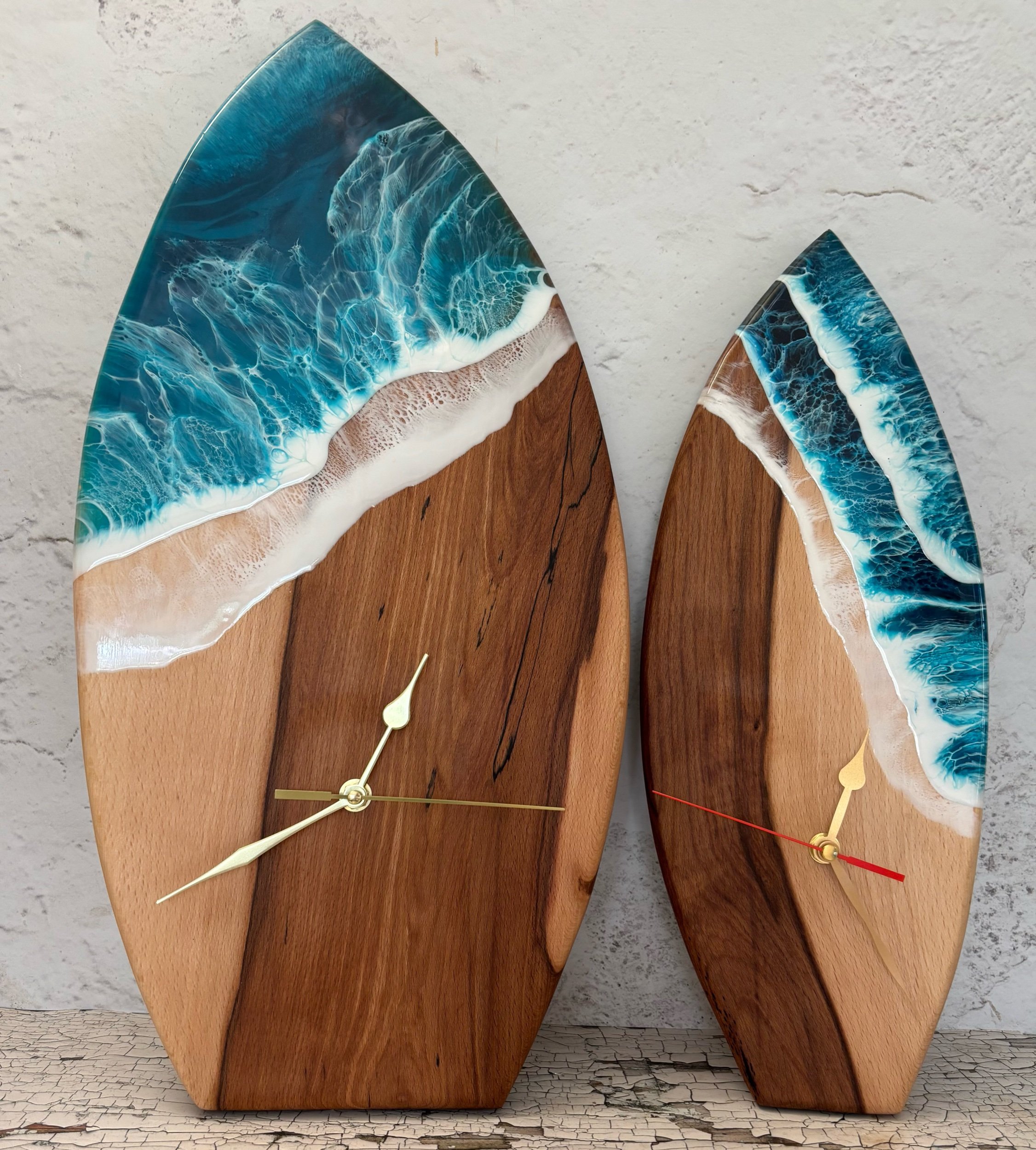 small and large surf board style clocks with ocean inspired resin art