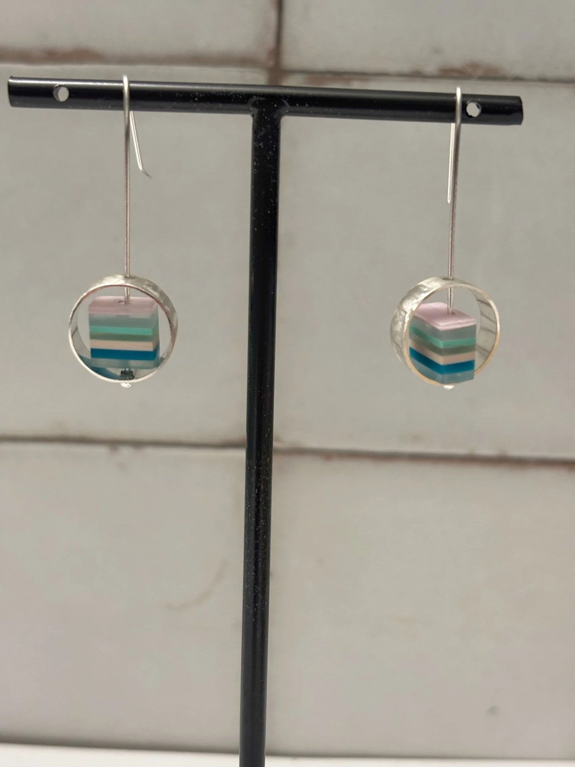 Handmade recycled silver earrings featuring textured bezels and layeres colour resin beads. Contemporary artisan jewllery designed for everyday wear