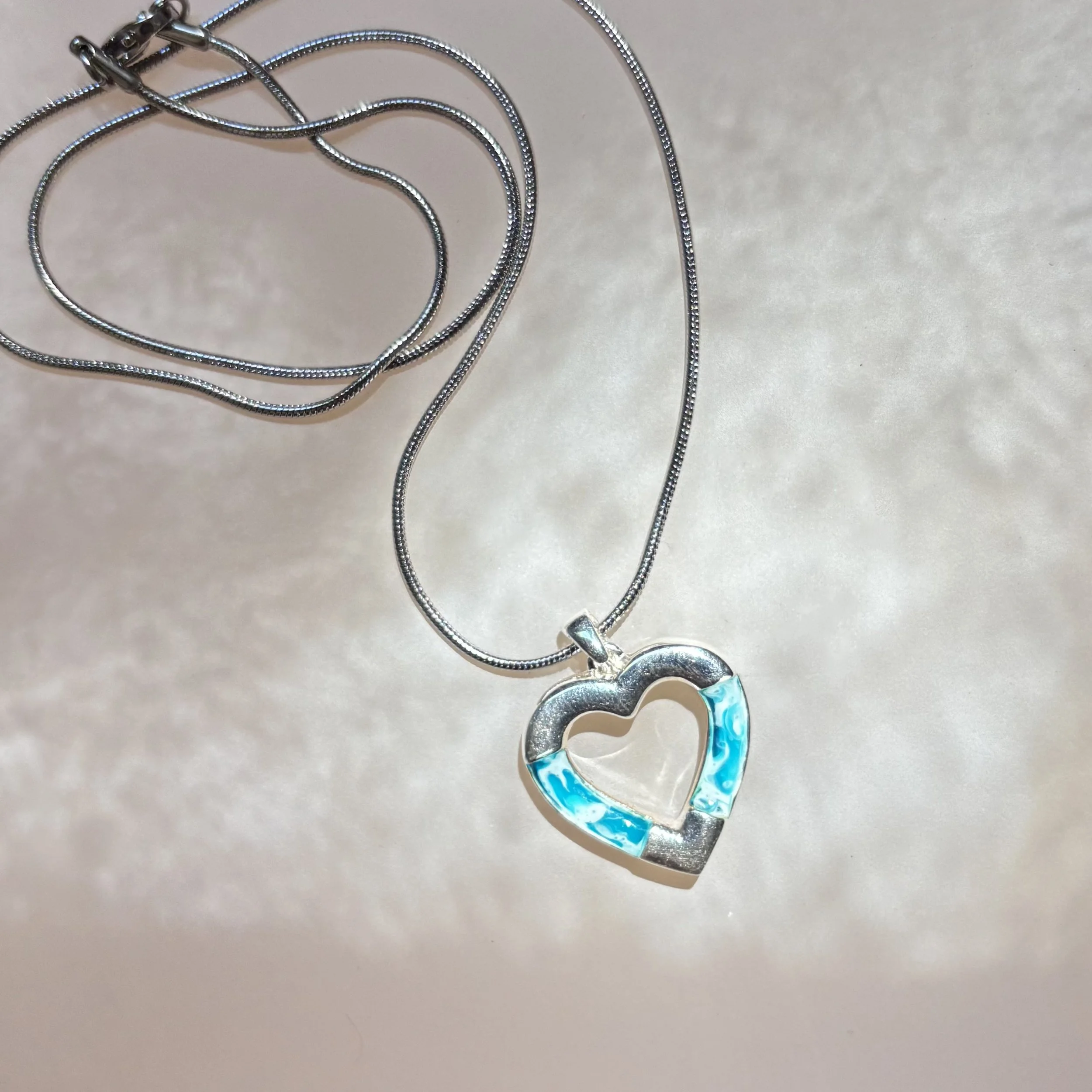 IMG_7453.jpeg heart shaped sterling silver heart with blue and white resin