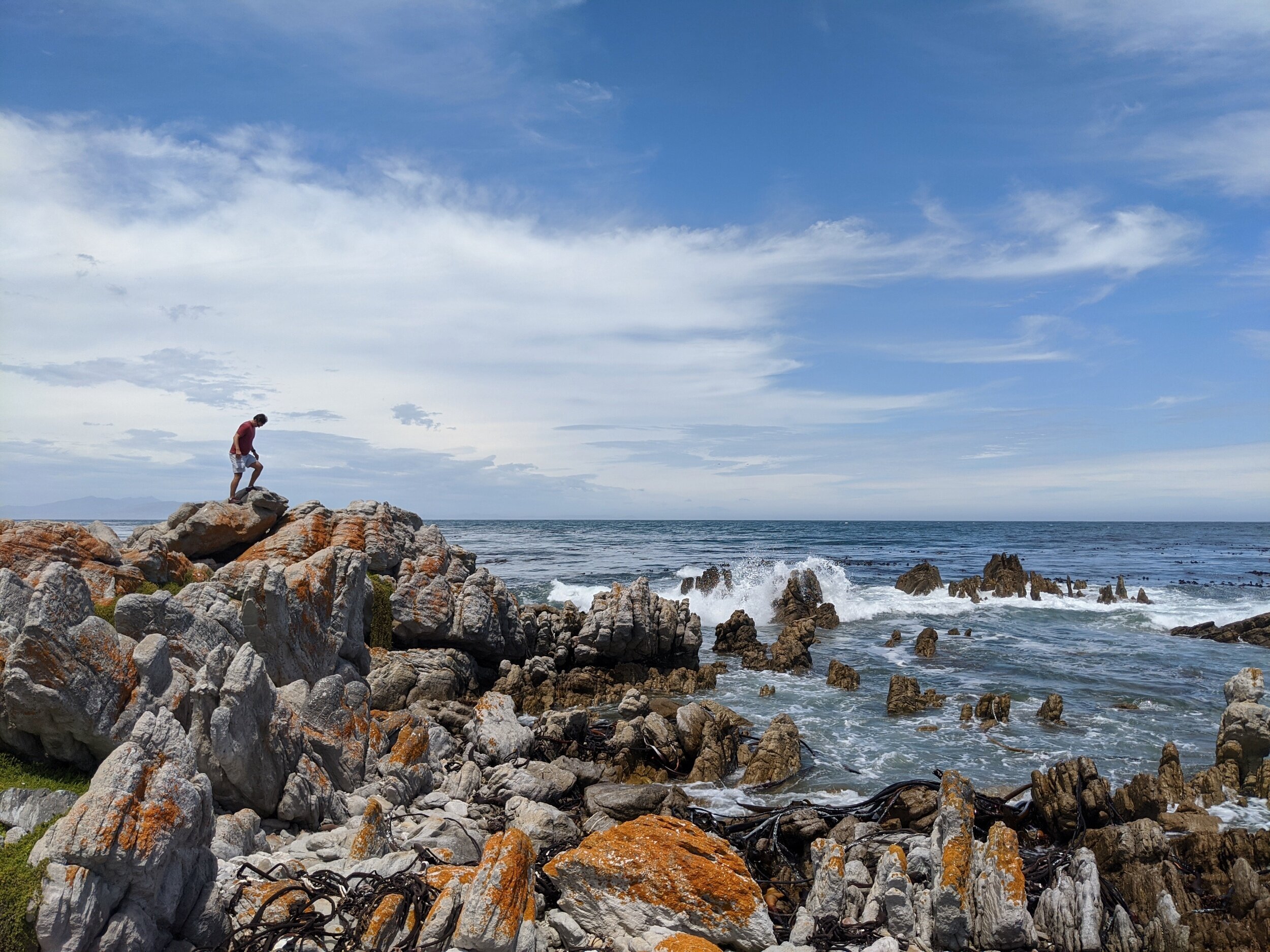 Jim climbing rocks with a view