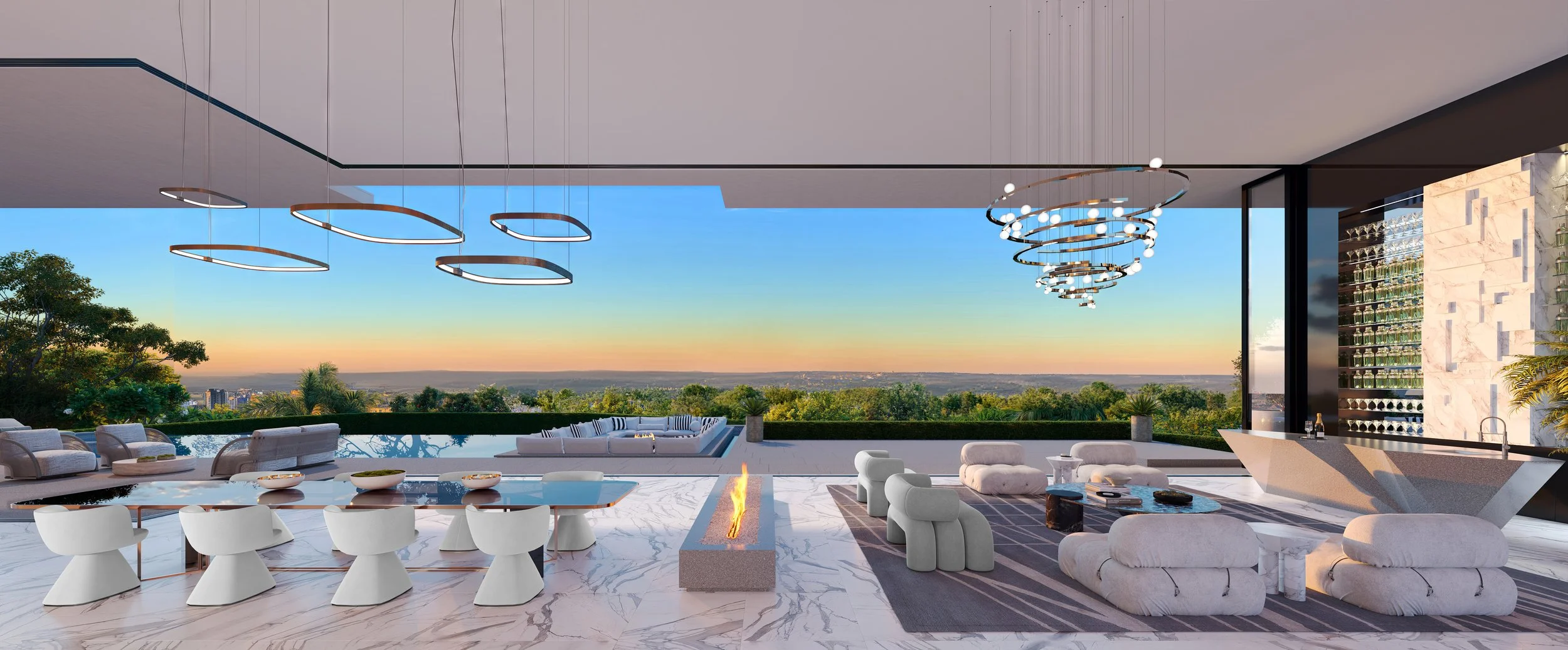 Modern outdoor rooftop lounge with white sofas, chairs, and a fire pit, overlooking a green landscape and sunset sky with stylish circular chandeliers hanging from the ceiling.
