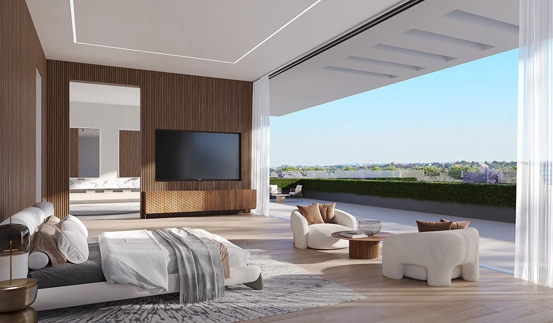 Modern bedroom and living area with large open balcony, wooden wall accents, flat-screen TV, white bed with beige accents, cozy seating with throw pillows, and transparent curtains with a panoramic view of a cityscape and greenery.