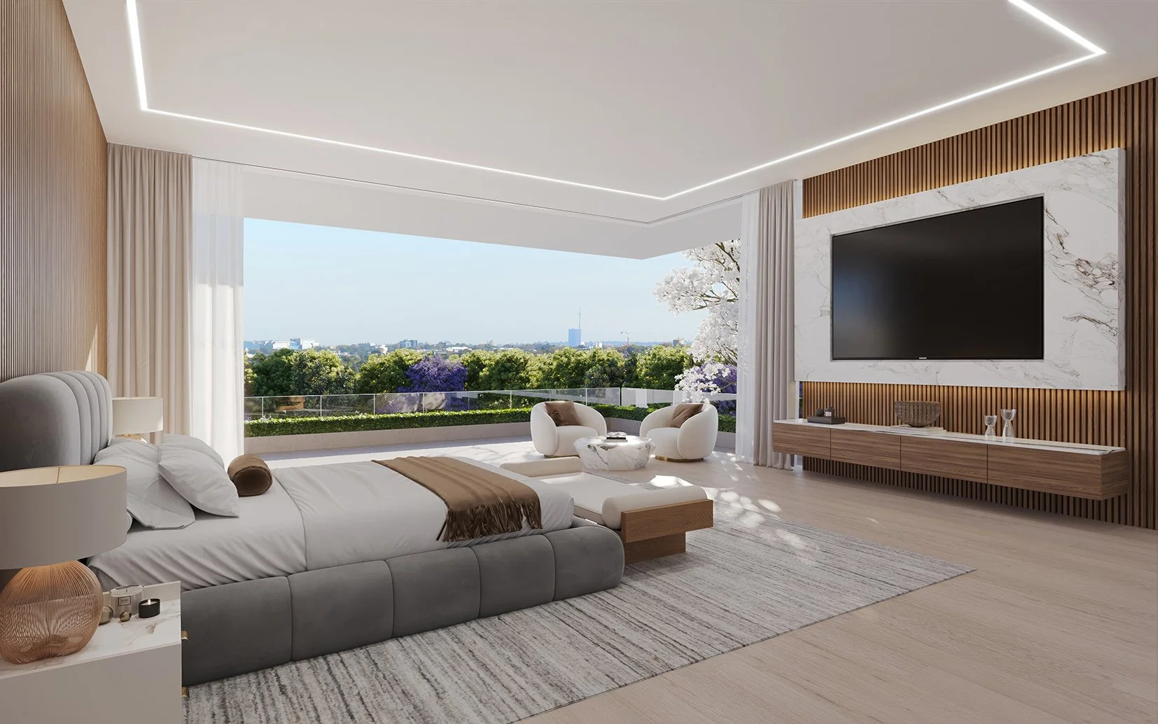 Modern bedroom with large window showing a scenic view of trees and a city skyline, including a tall building. The room features a gray upholstered bed with white bedding, a bedside table with a lamp, a patterned area rug, a sitting area with two white chairs and a small coffee table, a wall-mounted flat-screen TV, and wood and marble paneling on the walls.
