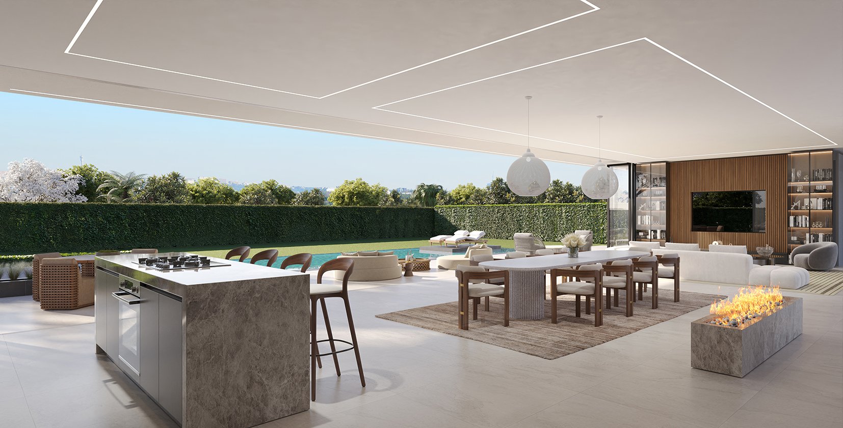 Open-concept outdoor living space with a kitchen island, dining area, and lounge near a pool, surrounded by greenery and a privacy hedge.