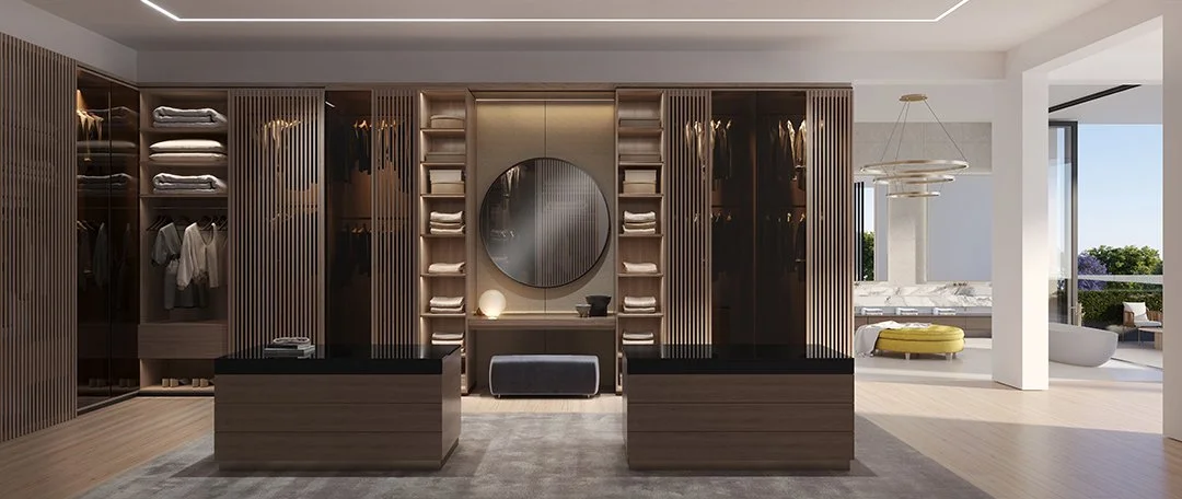 Modern walk-in closet with wooden shelves and hanging rods, drawers, a large round mirror, and a bench. Adjacent to a bright bedroom area with a yellow ottoman and outdoor patio.