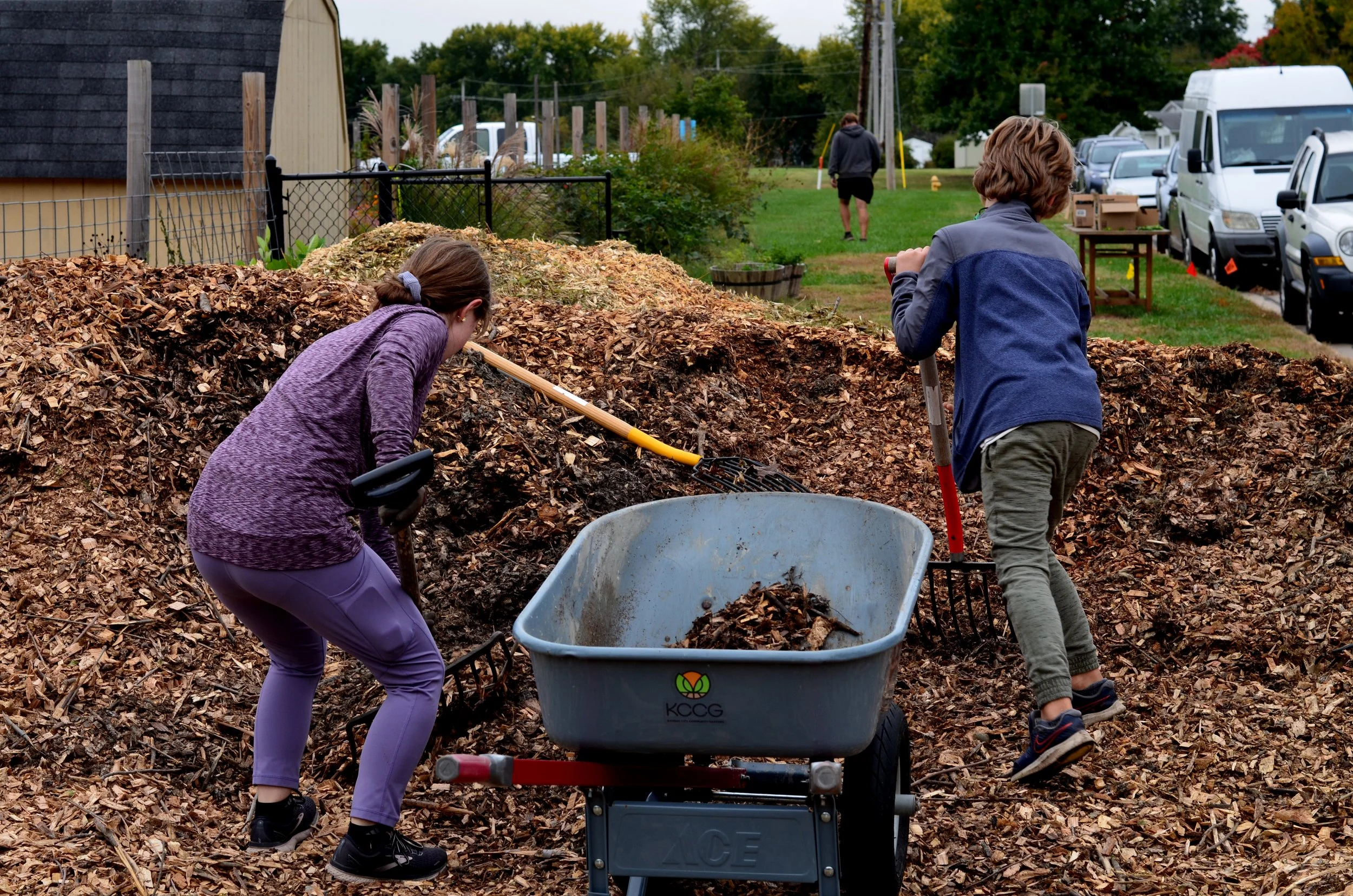 kids raking through a pile of mulch