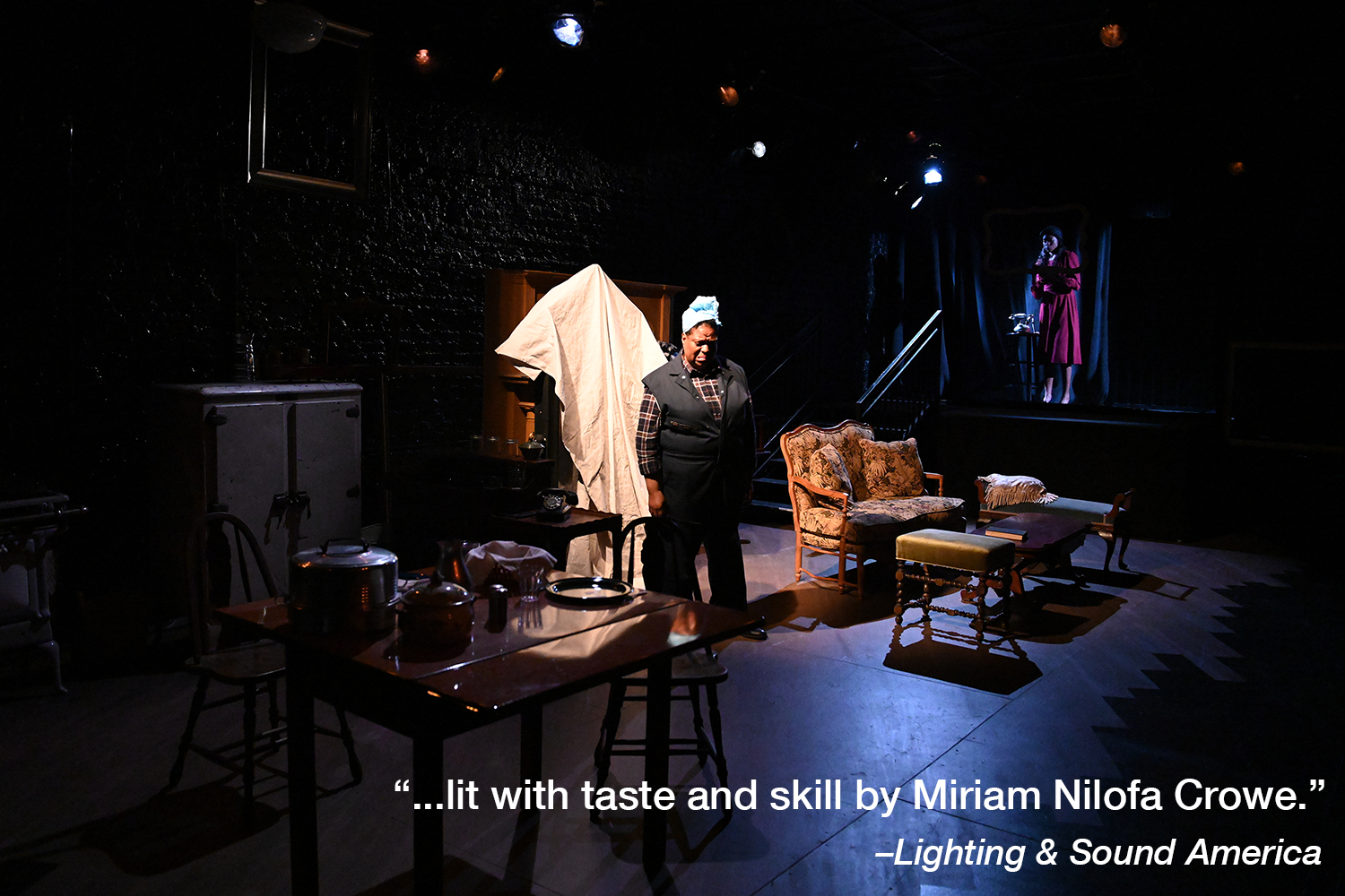  Suzanne Darrell (Bird Wilson) breaks down in her house, in a scene from  Mirrors . Kayland Jordan (Annabelle “Belle” Pierson) hovers behind. Photo by John Quilty.  A quote in white text reads “…lit with taste and skill by Miriam Nilofa Crowe -  Ligh