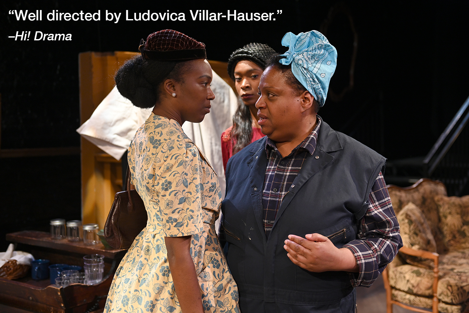  AnJu Hyppolitte (Mabel Mosley), and Suzanne Darrell (Bird Wilson), have a heated discussion in a scene from  Mirrors . Kayland Jordan (Annabelle “Belle” Pierson) peers from behind them. Photo by John Quilty.  A quote in white text reads “Well direct