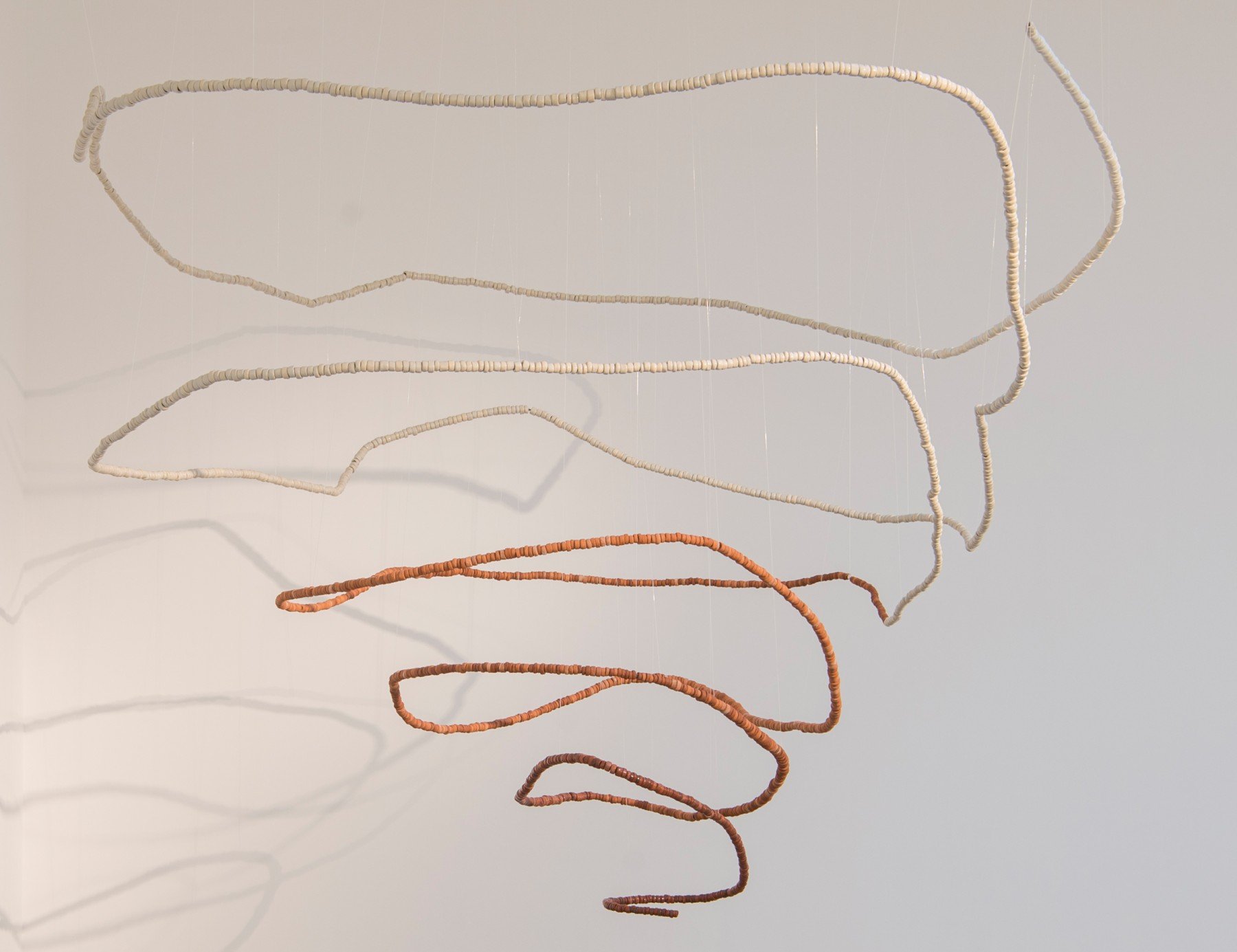 Taloi Havini, Beroana (Shell money) IV , 2016, stoneware, earthenware, clear glaze, steel wire, dimensions variable, courtesy Collection Sharjah Art Foundation, Andrew Baker Art Dealer, Bowen Hills, Queensland © Taloi Havini, photo: © Sharjah Art F