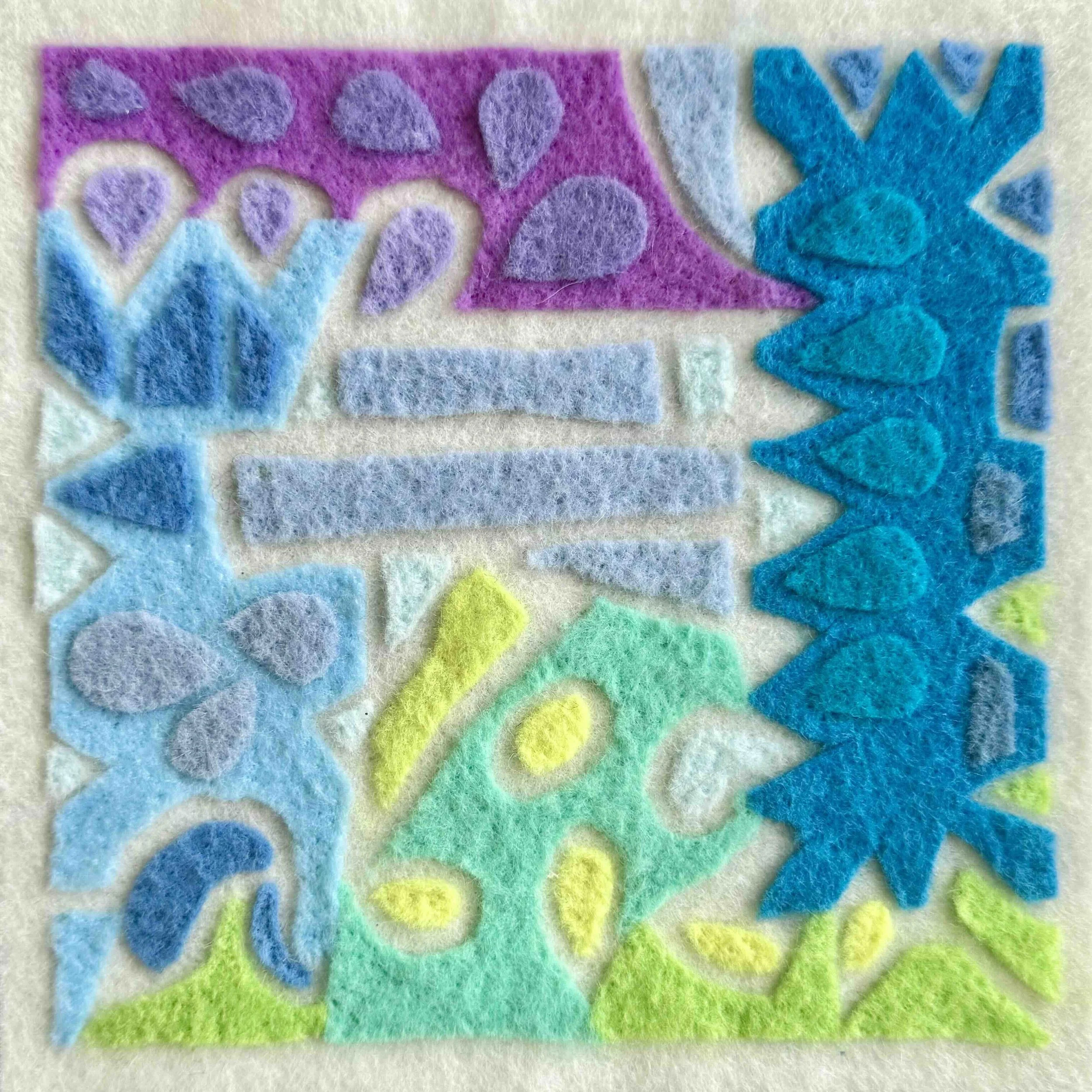 Colorful needle-felted artwork featuring abstract floral and organic shapes in blue, purple, and green tones.