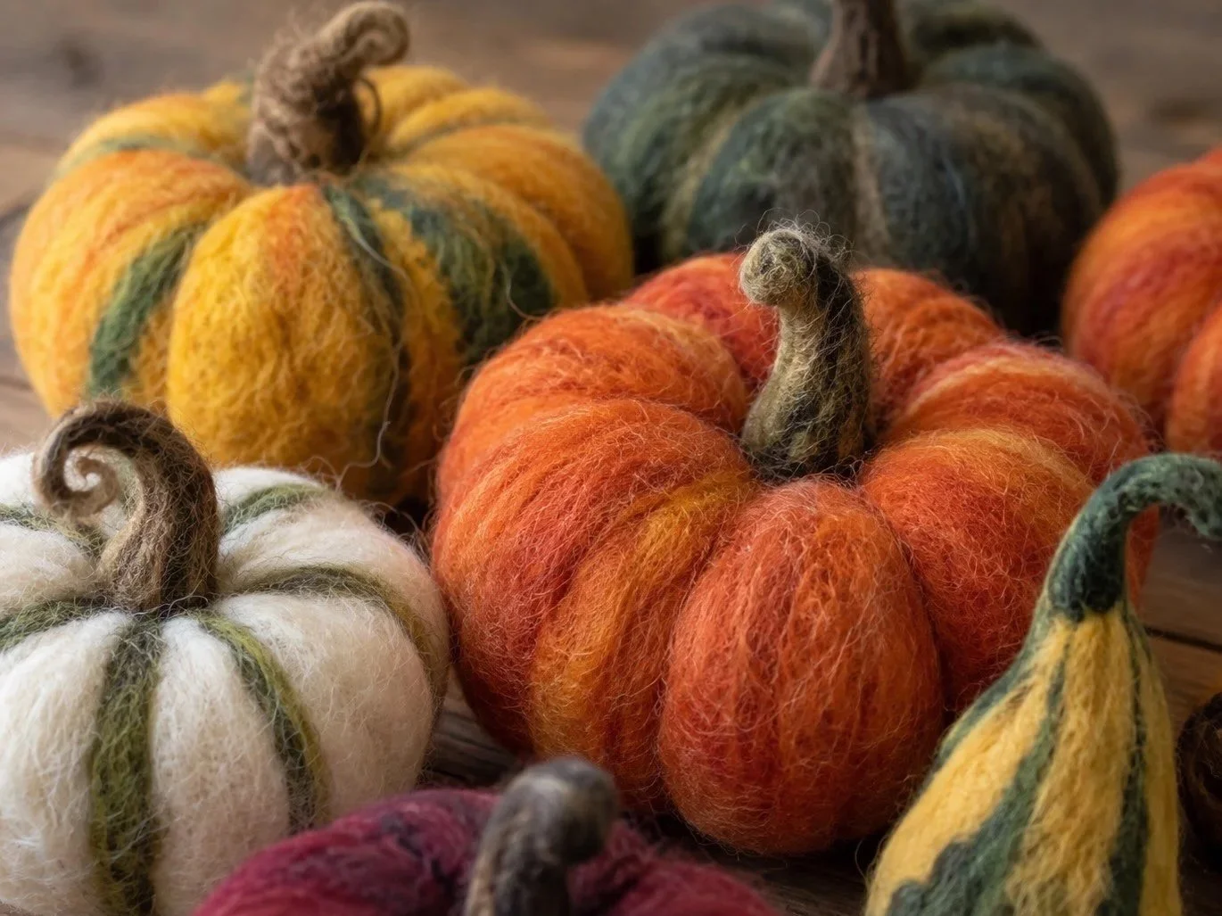 Examples of colorful needle felted pumpkins and gourds