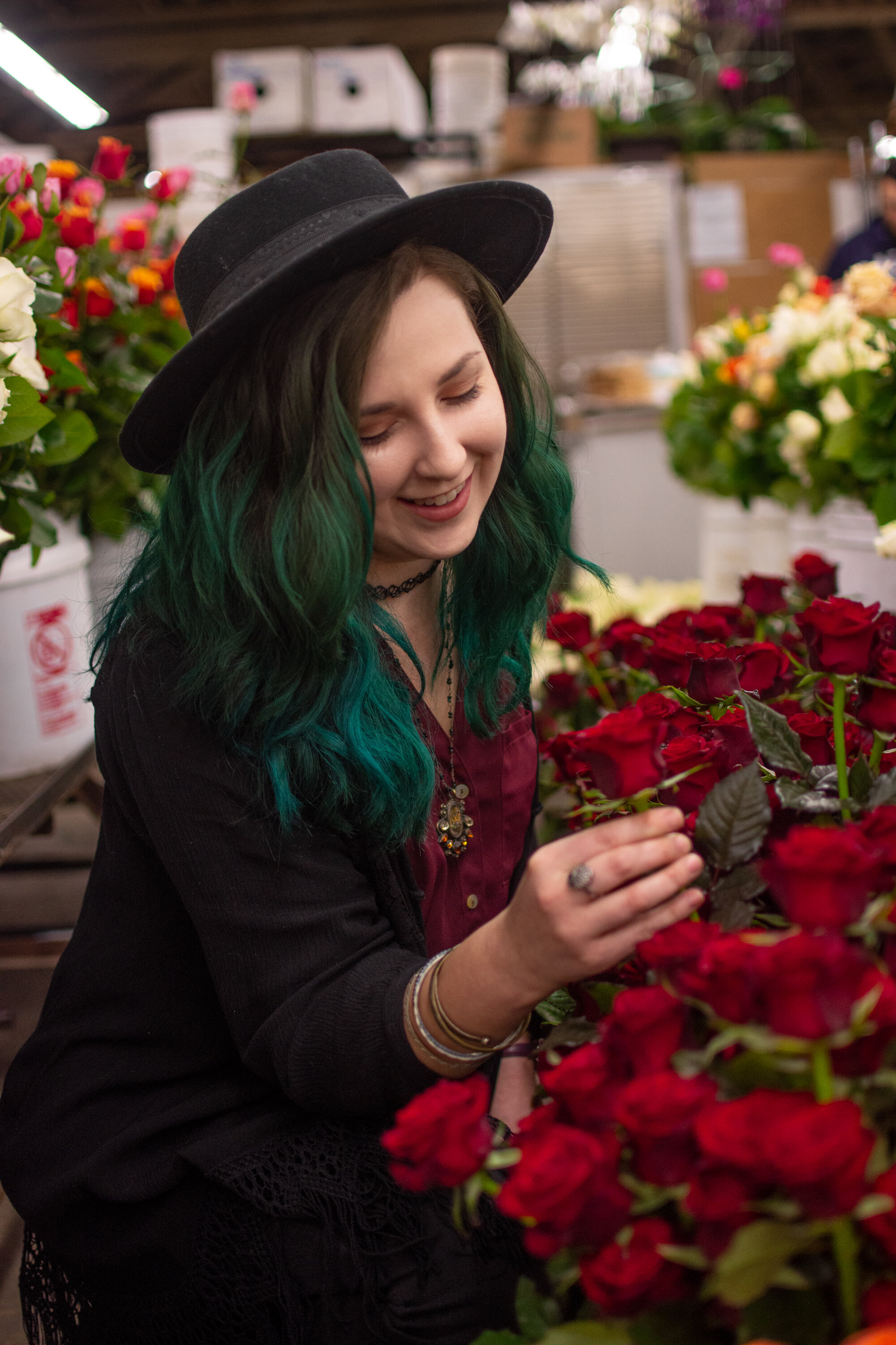 Florist in hat with red roses