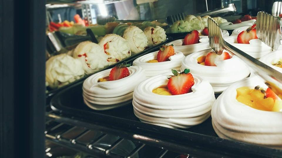 merengue cups in dessert cabinet.jpg