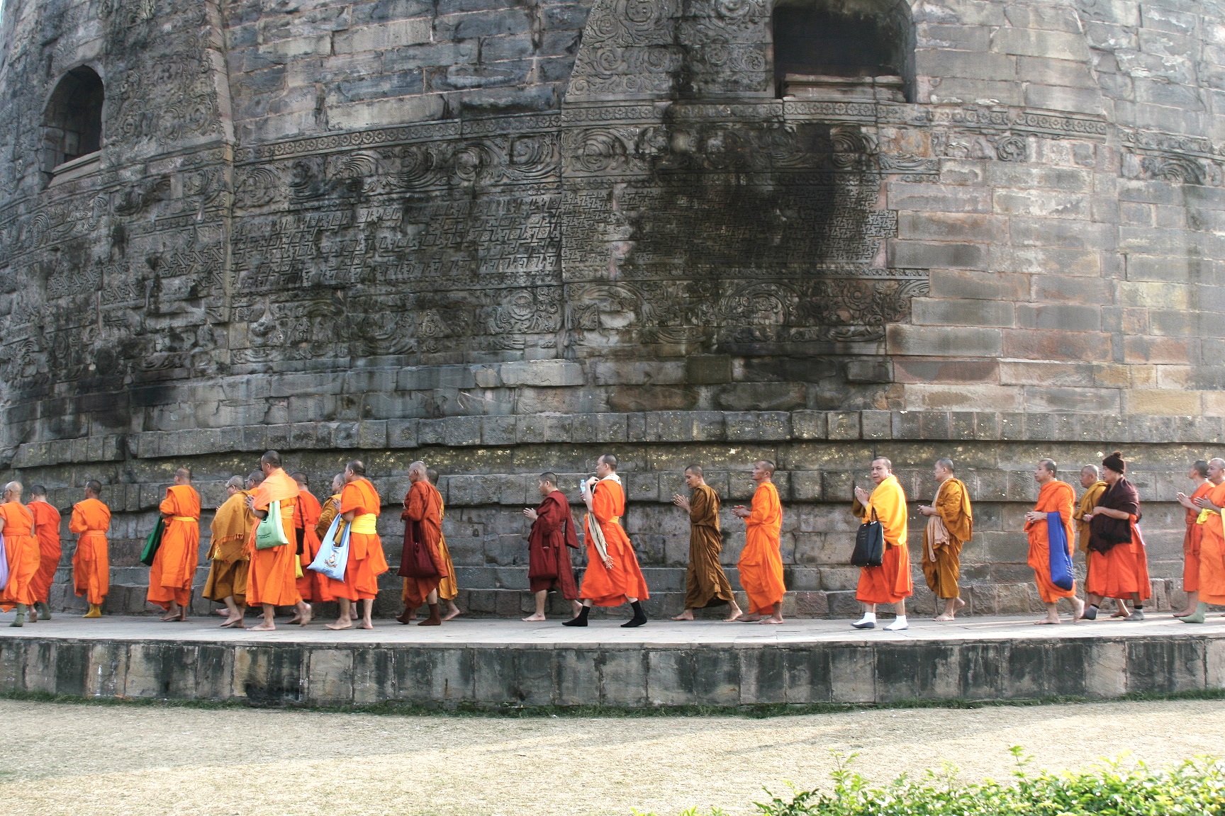 Buddhist monks circumambulating stupa at Sarnath, India