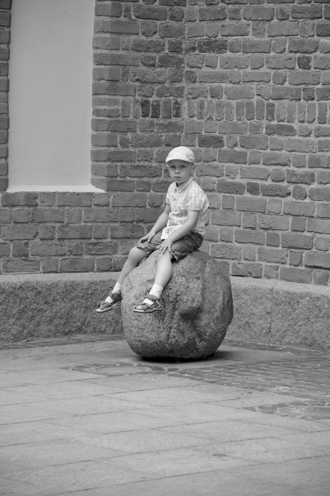 Young boy on boulder, Warsaw, Poland