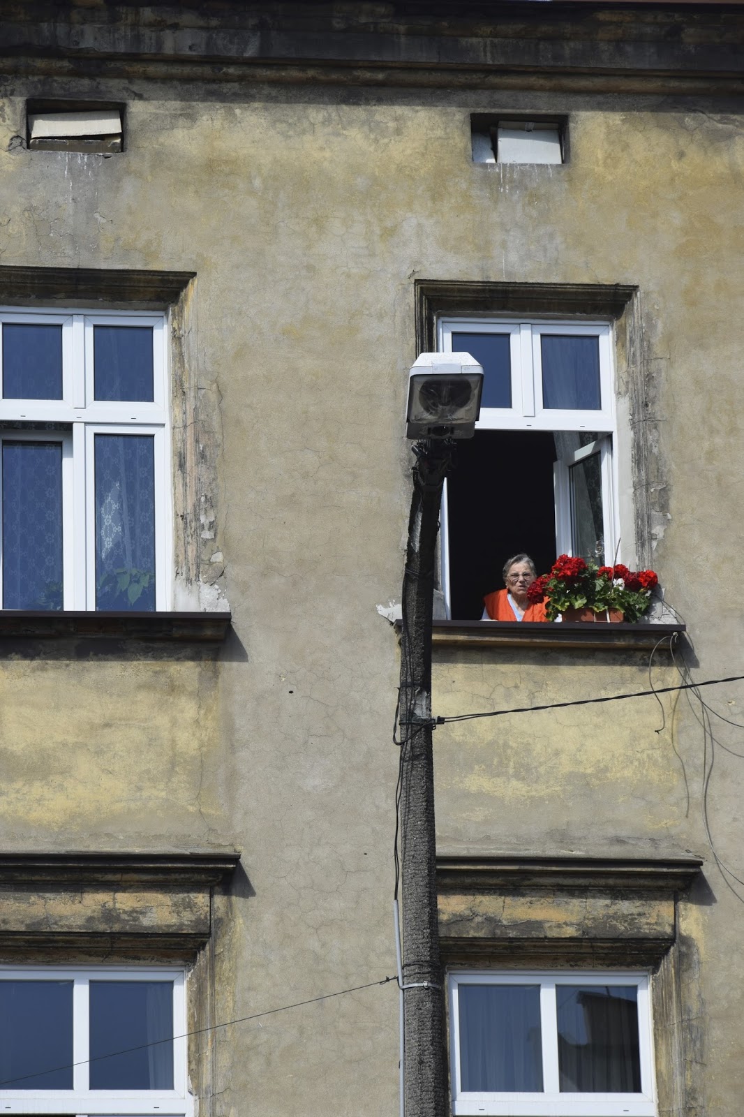 Woman at window, Kazimierz, Poland