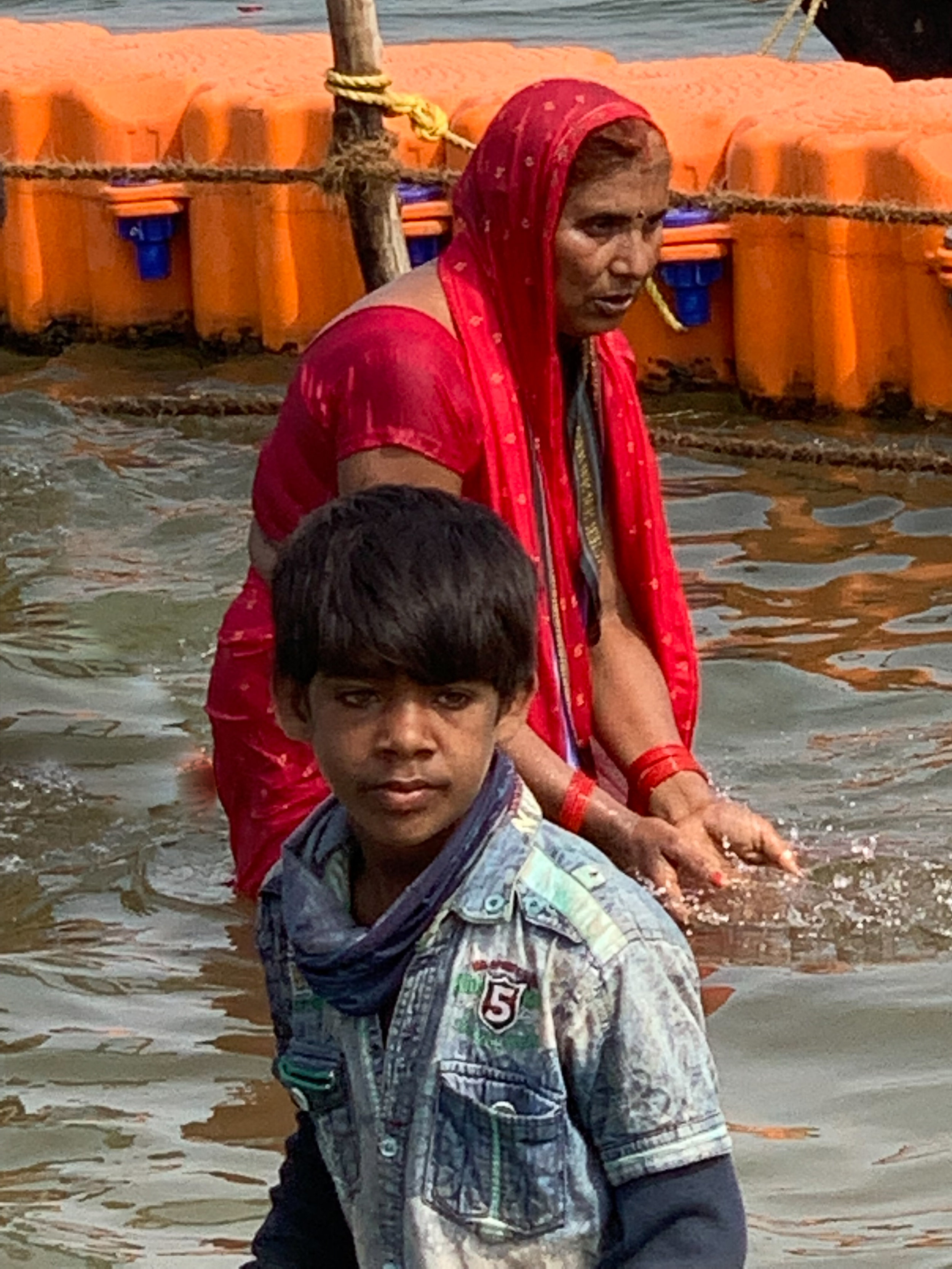Mother and son bathing on Royal Bath Day, Kumbh Mela, Prayagraj