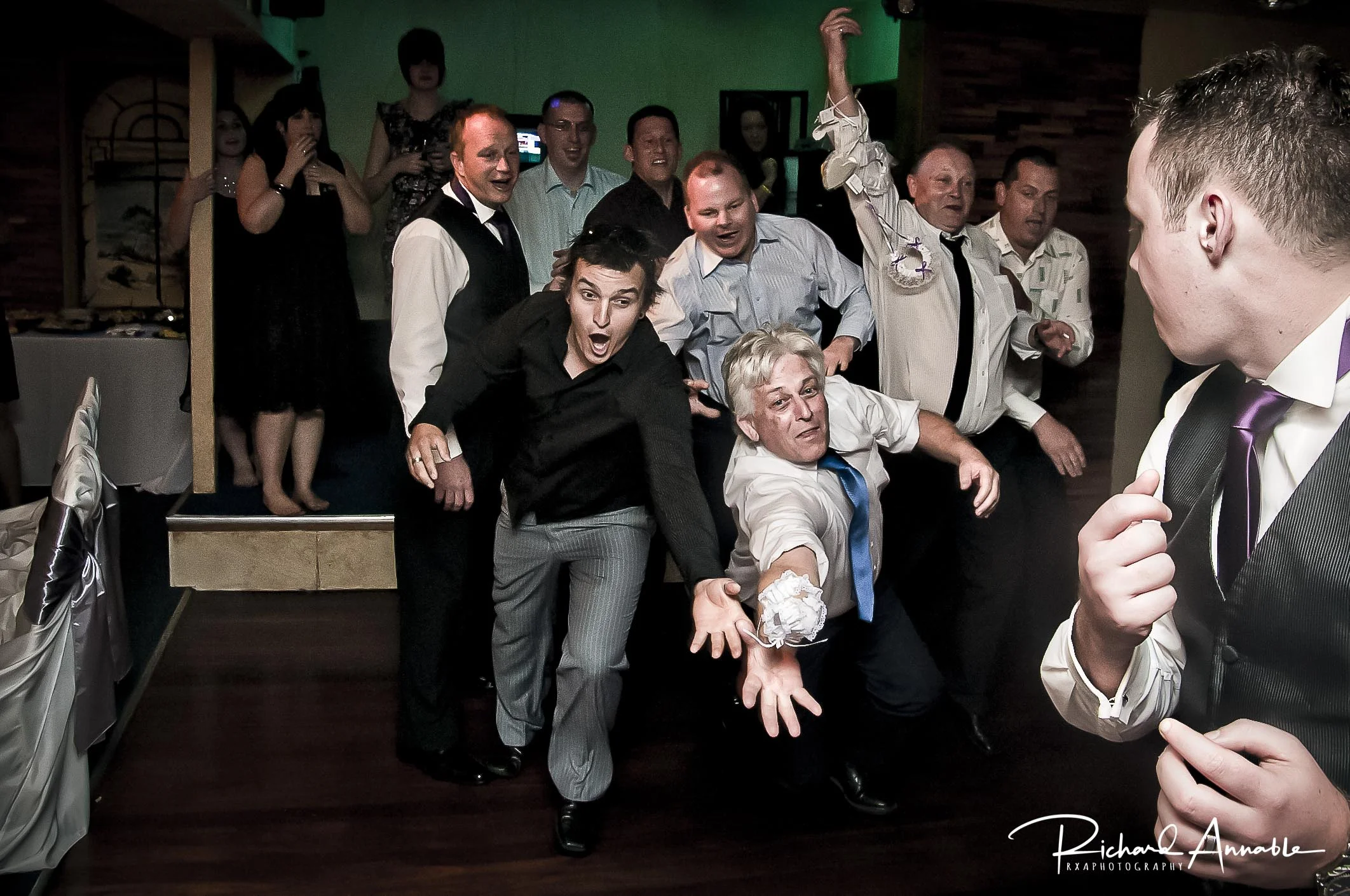 The men give it their all during Hannah & Jarrod’s garter toss.