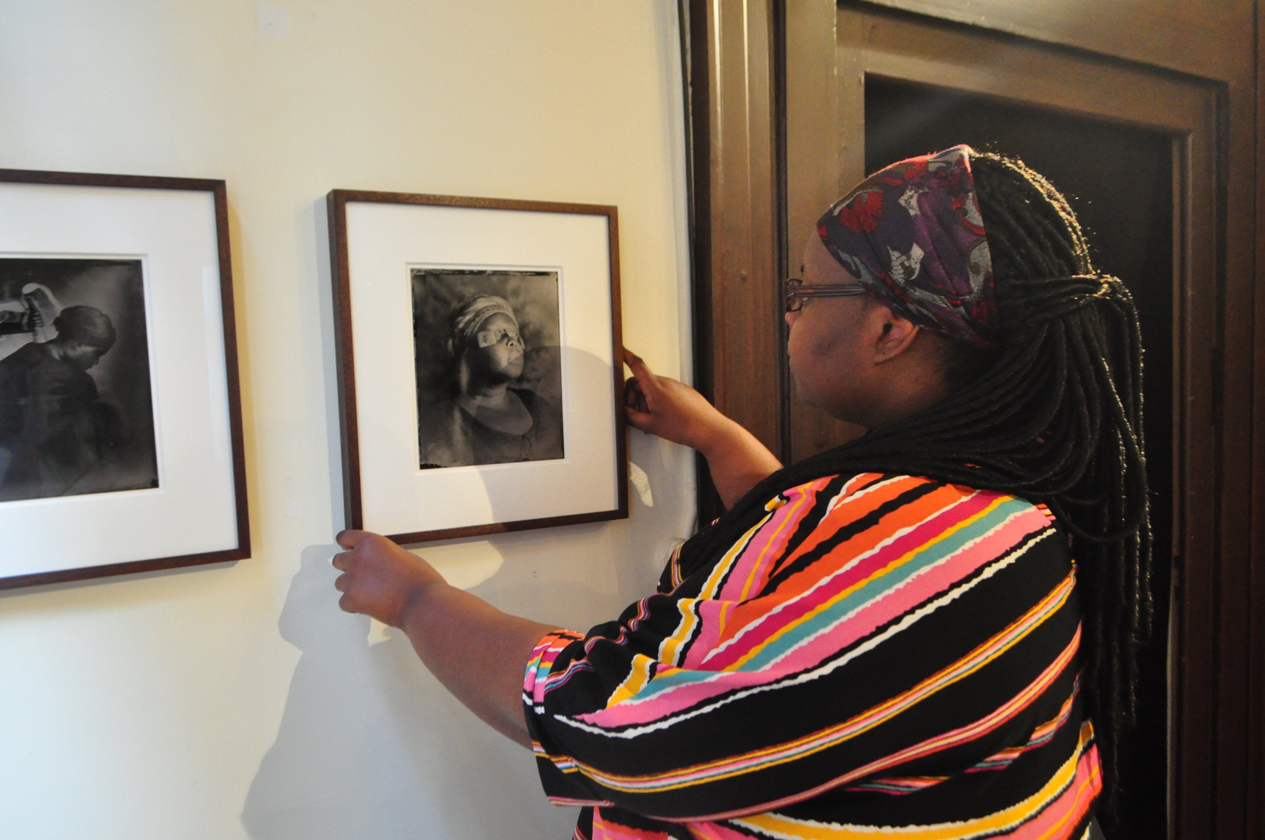 Khadija Saye hanging her work at the Diaspora Pavilion in 2017.  (Copy)