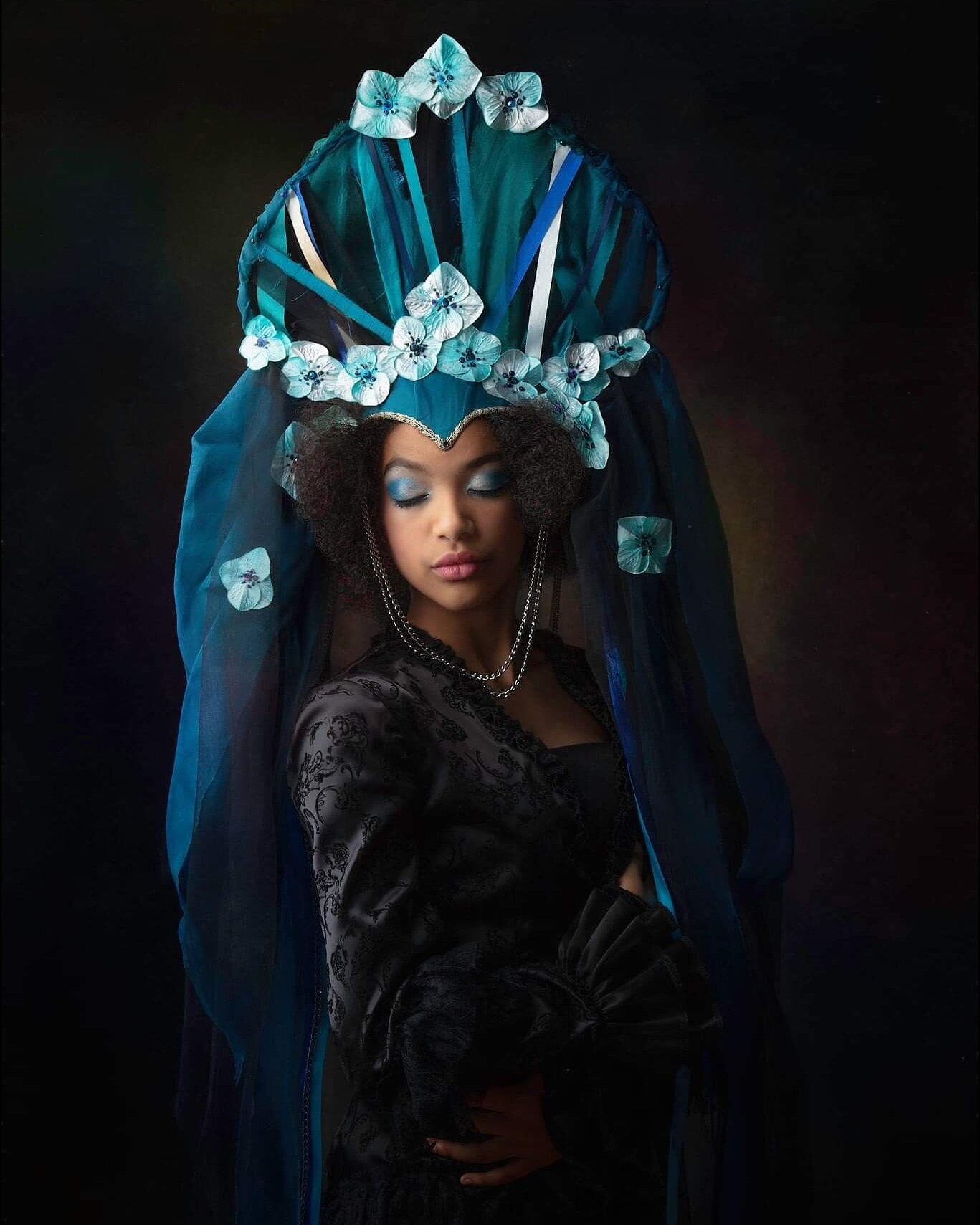 'Venyetta' an incredible headpiece in tones of blues and black, with a long dramatic veil.