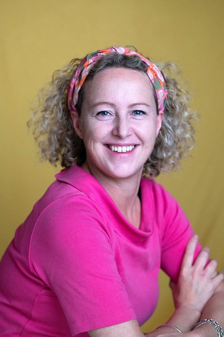 Professional headshot of woman in Bristol studio with coloured background