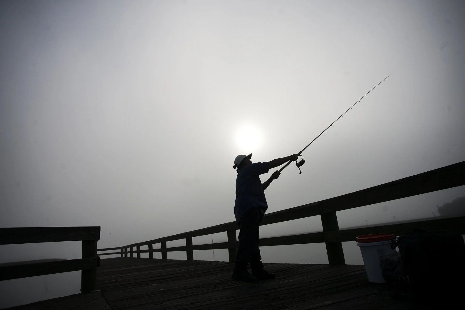  Early morning fog blankets much of gulf coast as Bobby Jadolon (cq), 69, of Brooksville a retiree casts his fishing pole at Bayport Park Pier on Tuesday, February 3, 2014. "I came out here to try my luck to catch something this morning," said Jadolo