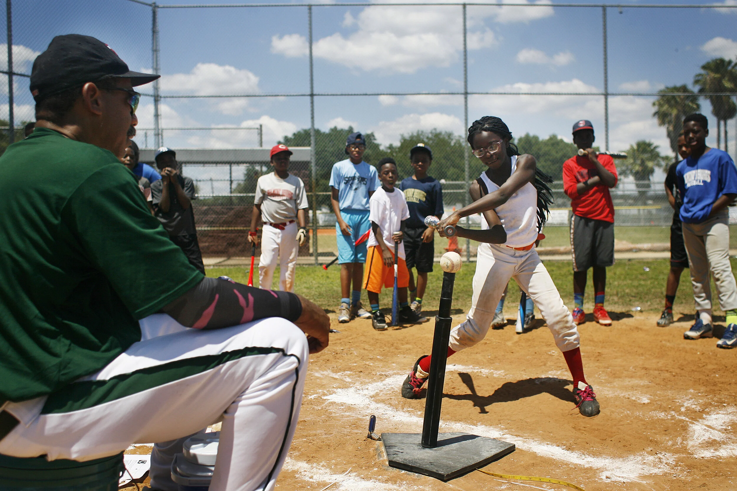  Former Major Baseball player Derek Bell, left, observes Quanshayla Melvin, 10, batting skills in the Scotts MLB's Pitch, Hit and Run competition where Coach "Ms Ann" Sullivan was honored with the Pioneer Award at the Belmont Heights Baseball Complex
