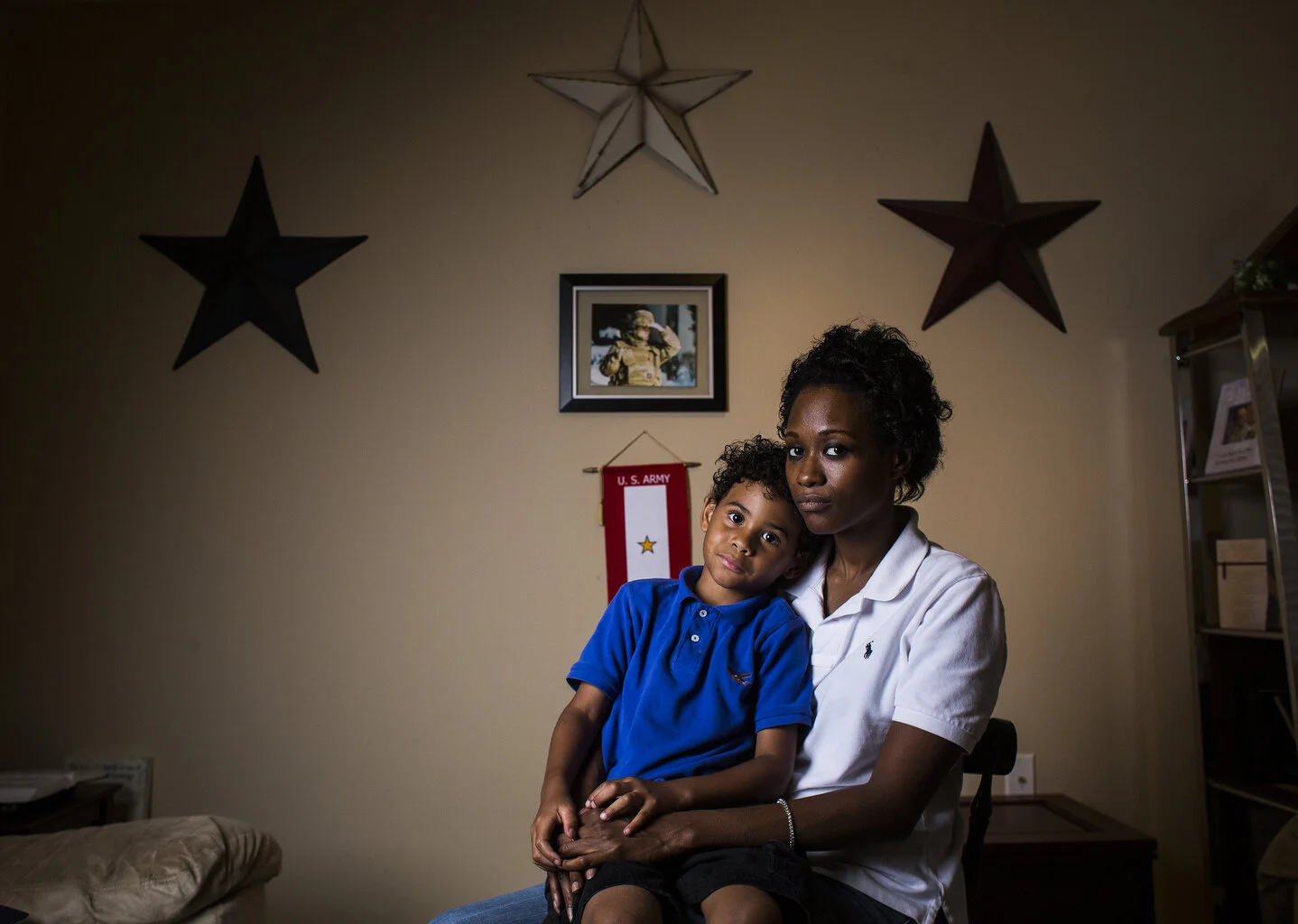  Brittany Jackson-Marquis of Riverview holds her 5-year-old son Christopher Marquis in a room she dedicated to there late husband Army Spc. Christophe Marquis(cq). Marquis(cq) who was in the 1st Battalion 25th Infantry Division, died from his injurie