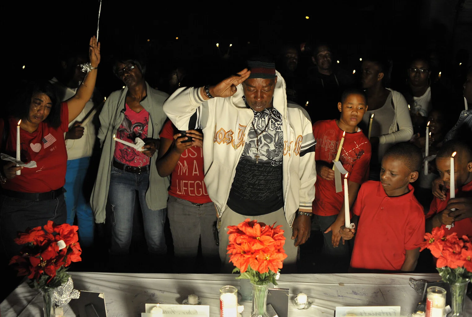  Jerome Morrison, center, salutes in front of a shrine dedicated to the victims who were killed in Plant City, Florida.  