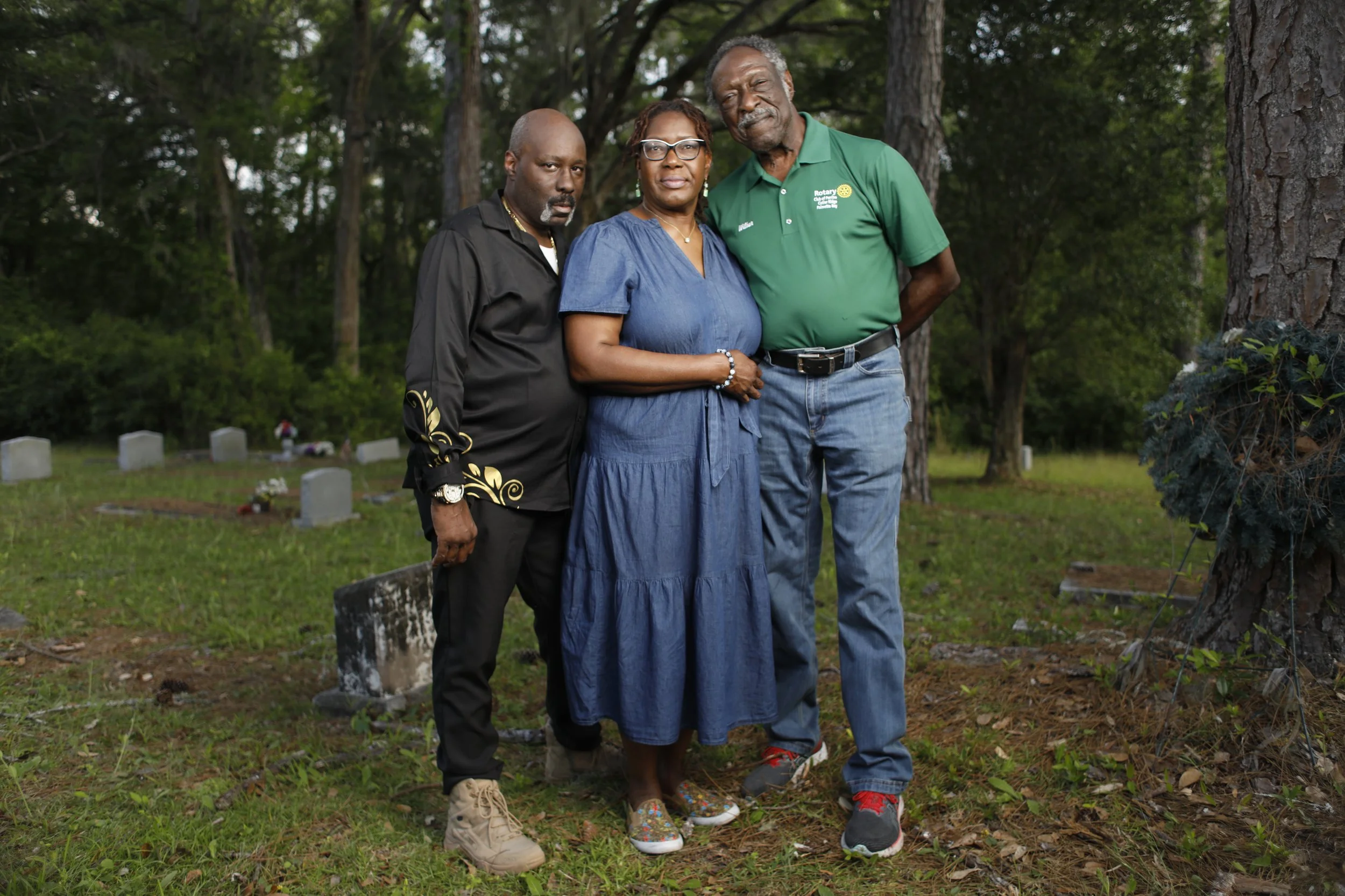 Wilbur Bell, his daughter Desiree Bell Davis and nephew Vincent Bell pose for a photo at the Falling Creek Baptist Church cemetery in Lake City, Florida. Octavio Jones for CNN
