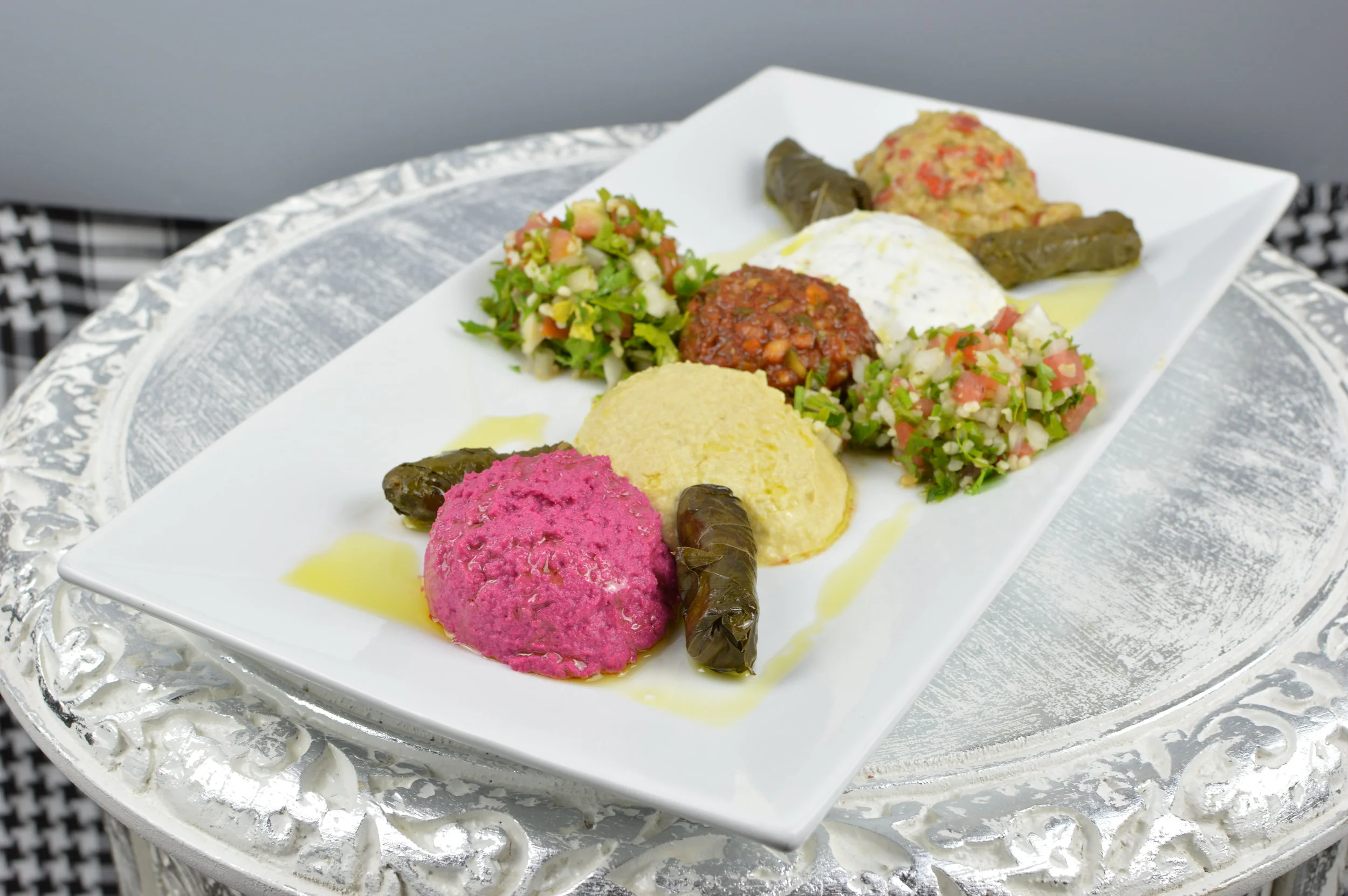Appetizer Platter Ezme, Baba ghanoush, Stuffed grape leaves, tabbouleh, Haydari and  Choice of Humus (Plain or humus with beet) $11.95