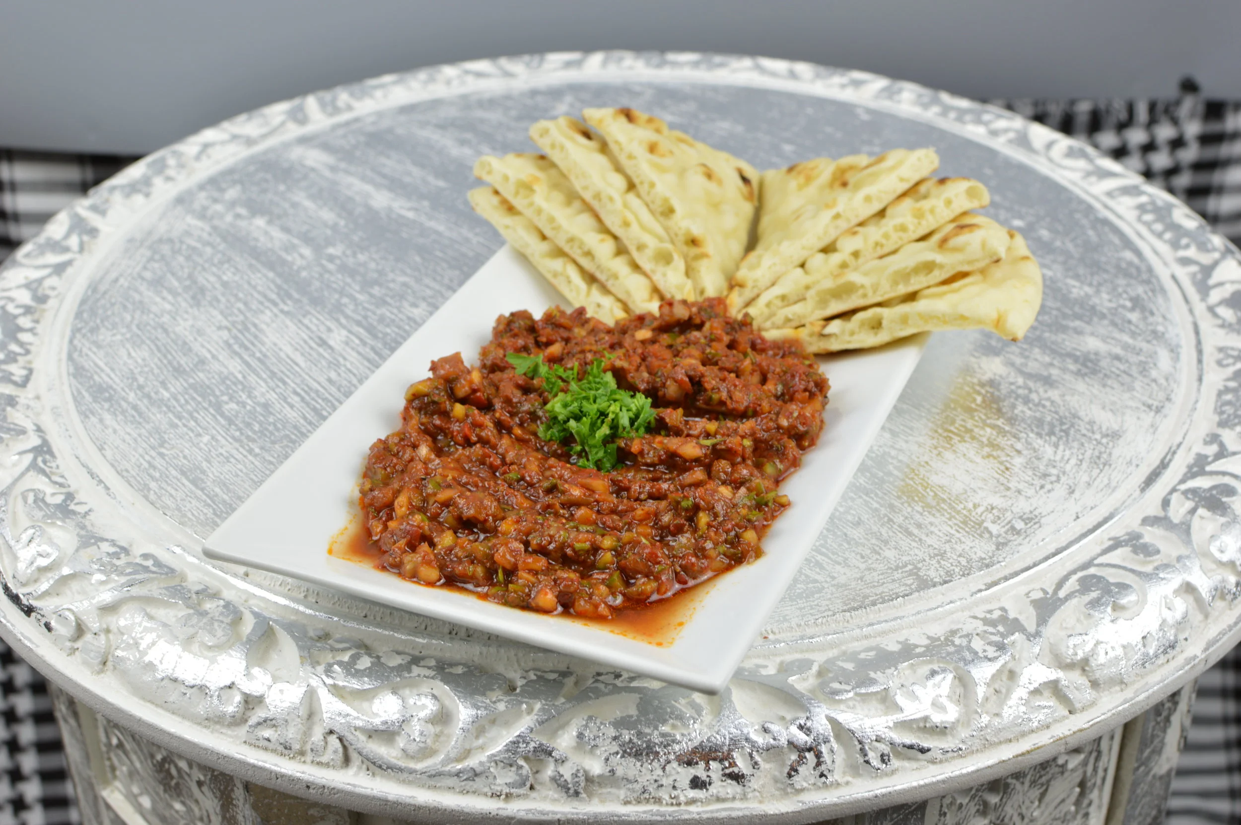 Ezme (Turkish Salsa) - Delicious mixture of fresh tomatoes, red and green peppers, onions, parsley, olive oil, fresh lemon juice, pomegranate molasses, and special Turkish spices. $5.95