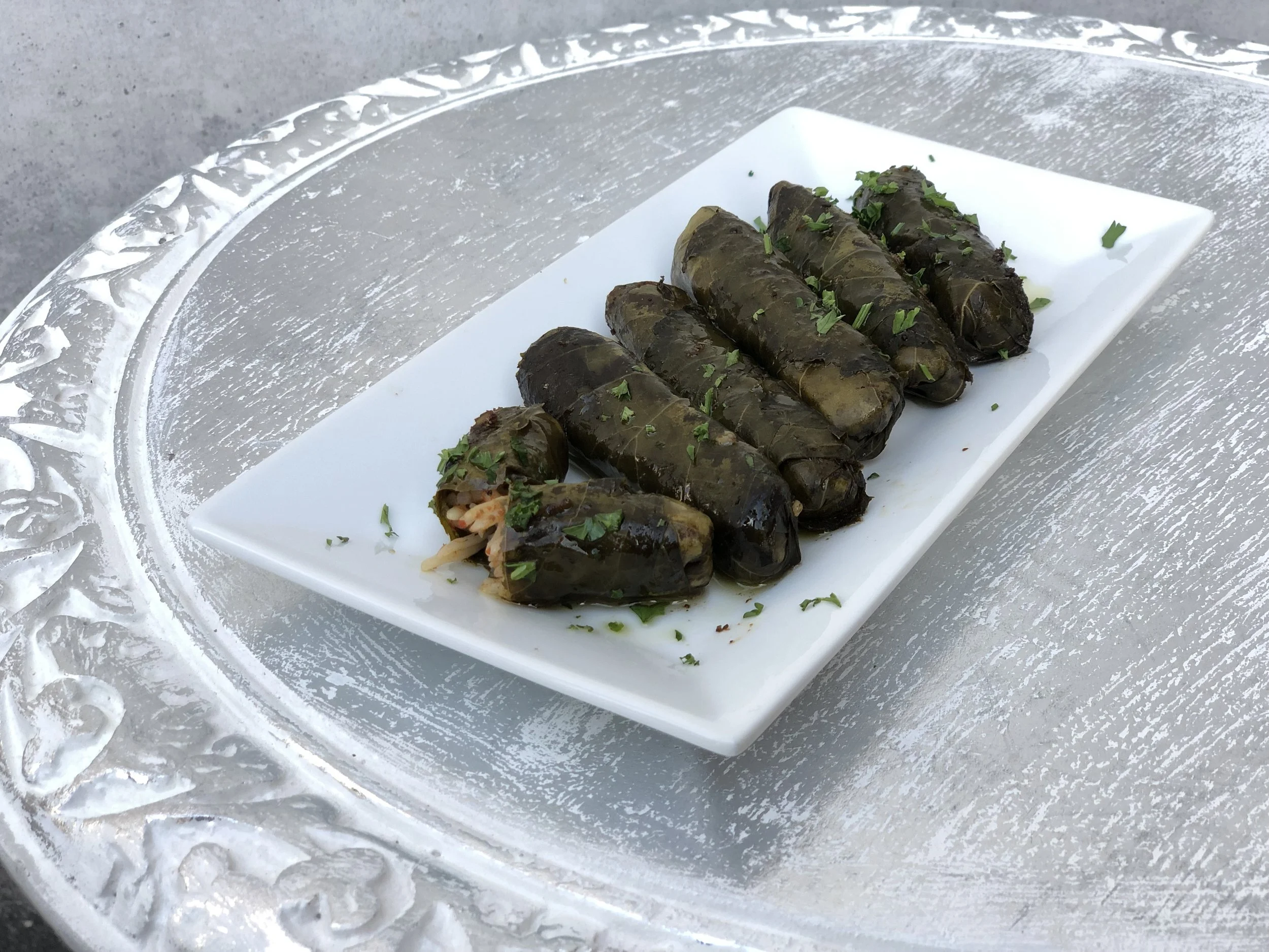 Yaprak Sarma (Stuffed Grape Leaves) - Grape leaves stuffed with rice, onions, and tomatoes seasoned with lemon juice, olive oil and special Turkish spices. $5.95