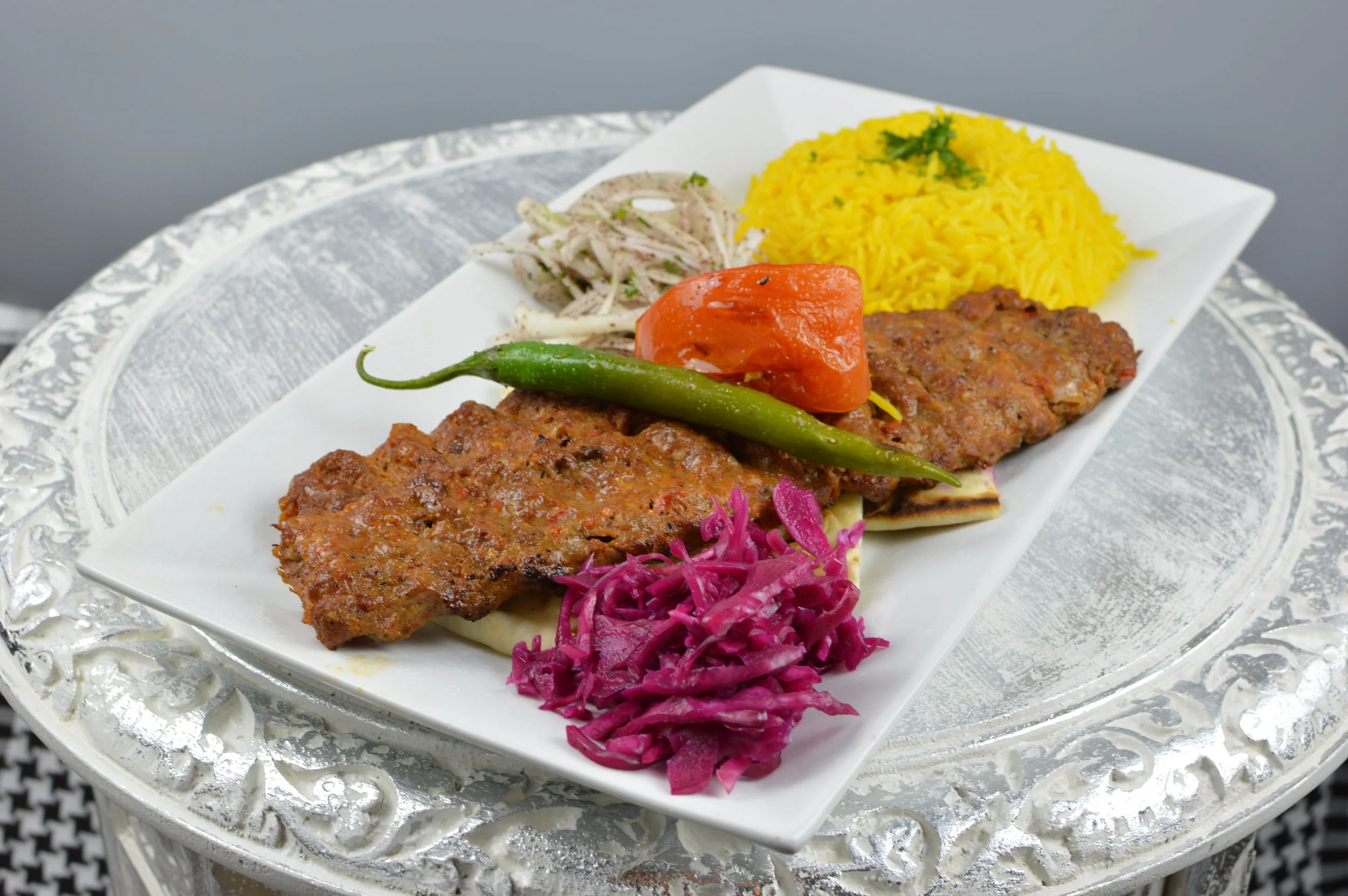 Adana Kabob - Two skewers of chargrilled ground lamb and beef mixed with herbs and Turkish spices. Served with rice and salad. $13.95
