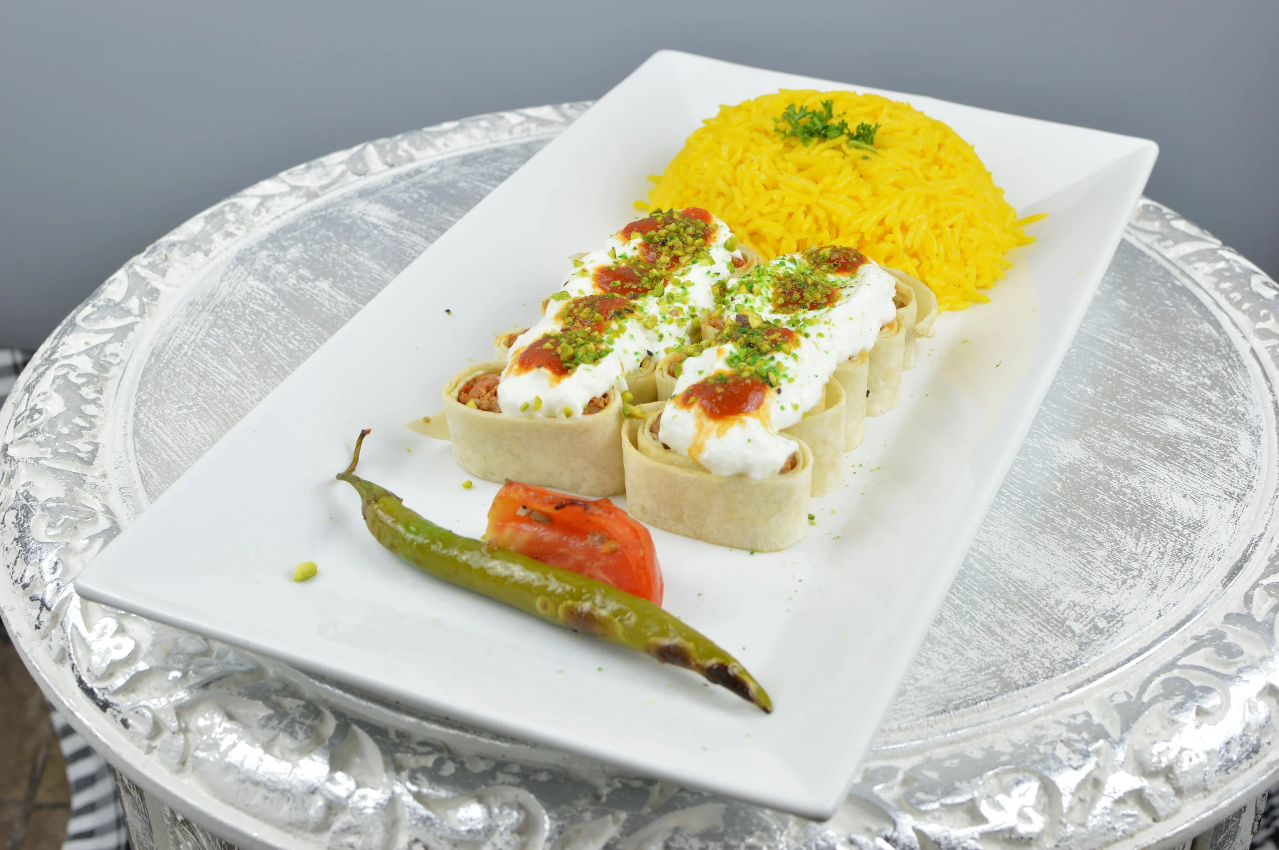 Beyti - Grilled quality ground lamb and beef mixed with herbs and vegetables and wrapped in lawash. Served with yogurt, tomato sauce, rice and salad. $13.95