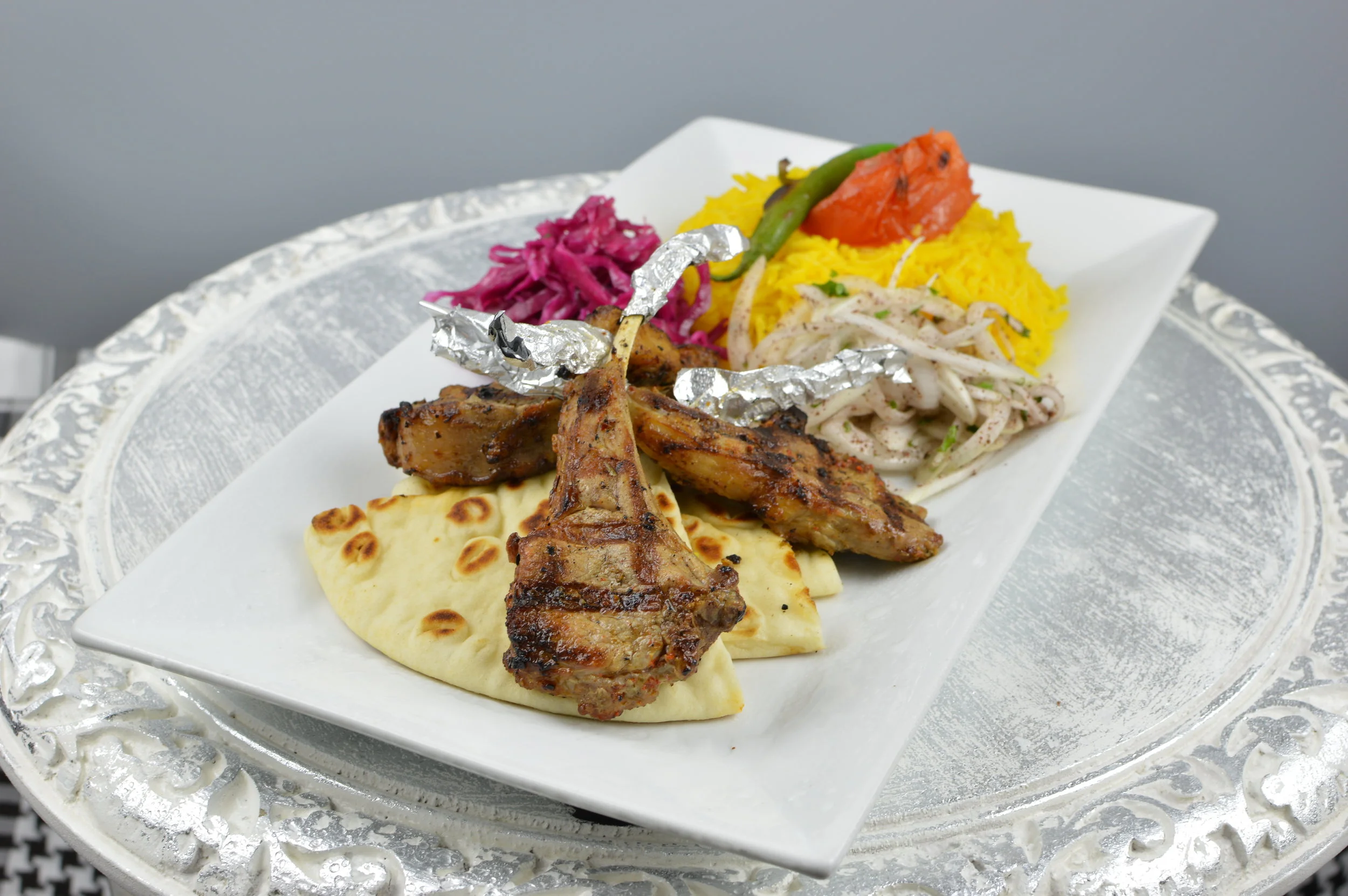 Kuzu Pirzola (Lamb Chops) - Marinated and chargrilled four baby lamb chops. Served with rice and salad. $19.95