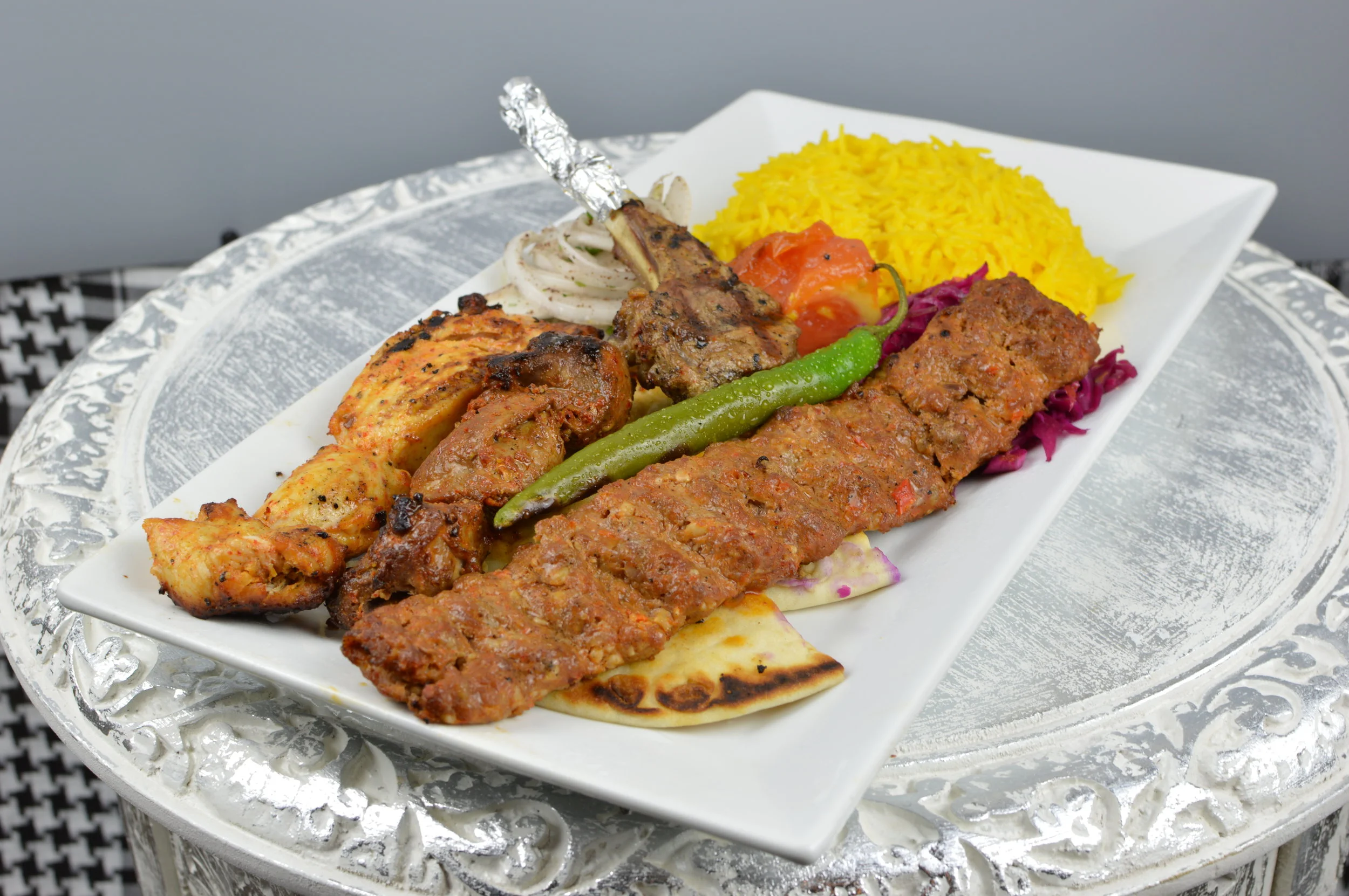 Mixed Grill Kabobs - A combination of chargrilled Fillet Mignon, chicken, Adana kabob, and lamb chop. Served with rice and salad. $19.95