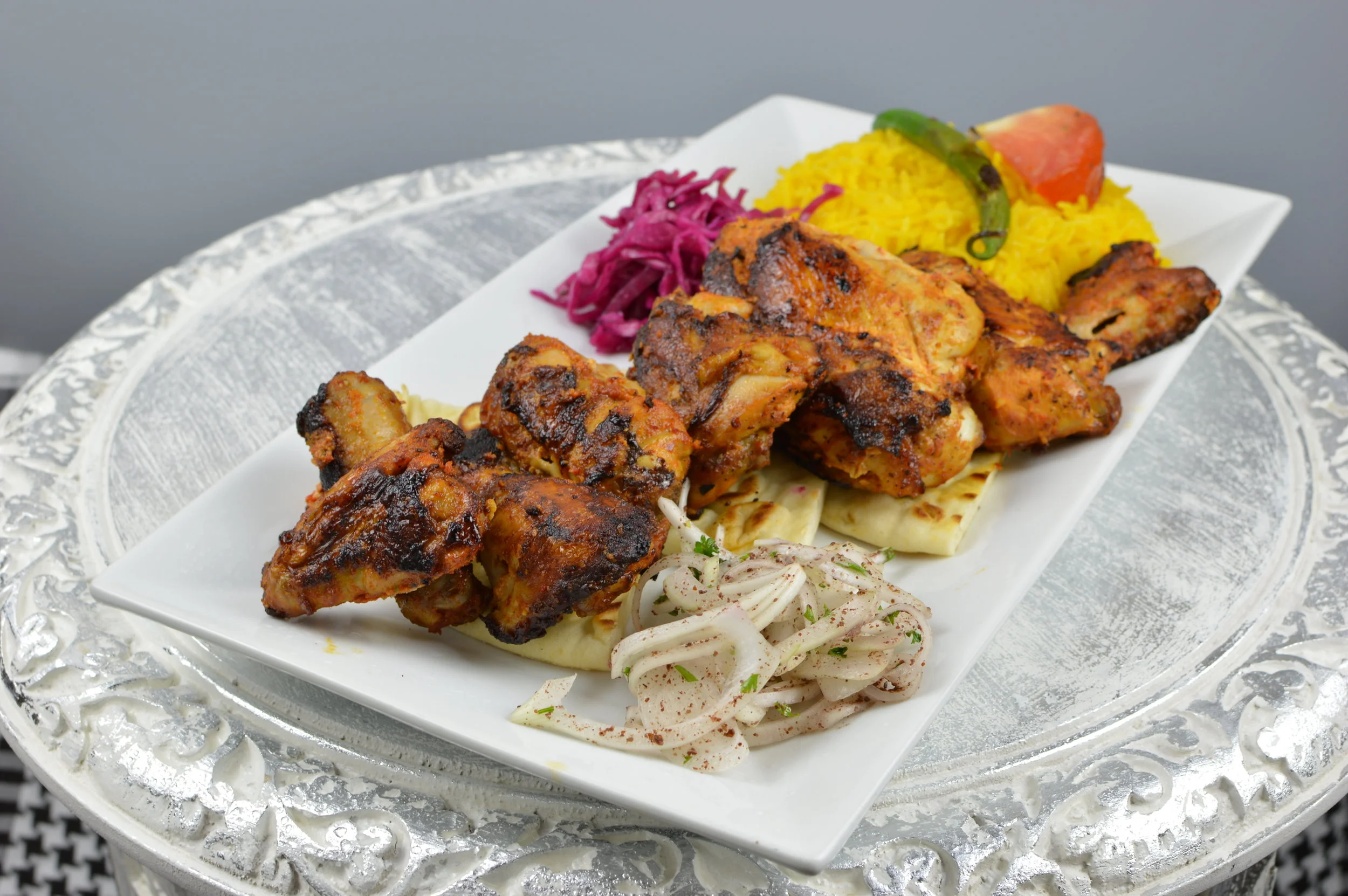 Cornish Chicken - Chargrilled skewer of whole Cornish chicken marinated in special sauce. Served with rice and salad. $13.95