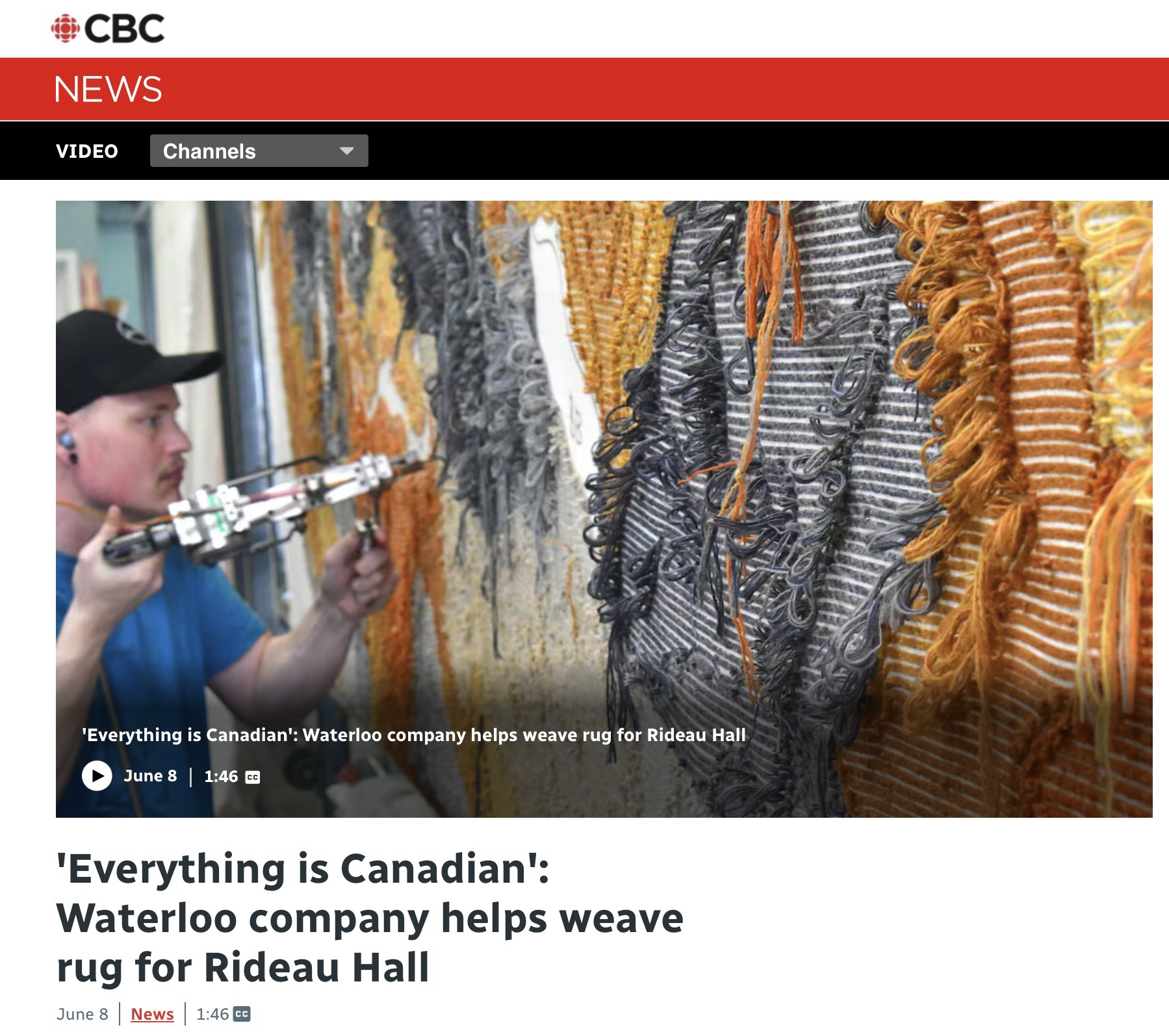 A man in a baseball cap uses a tufting gun to tuft a wool carpet.
