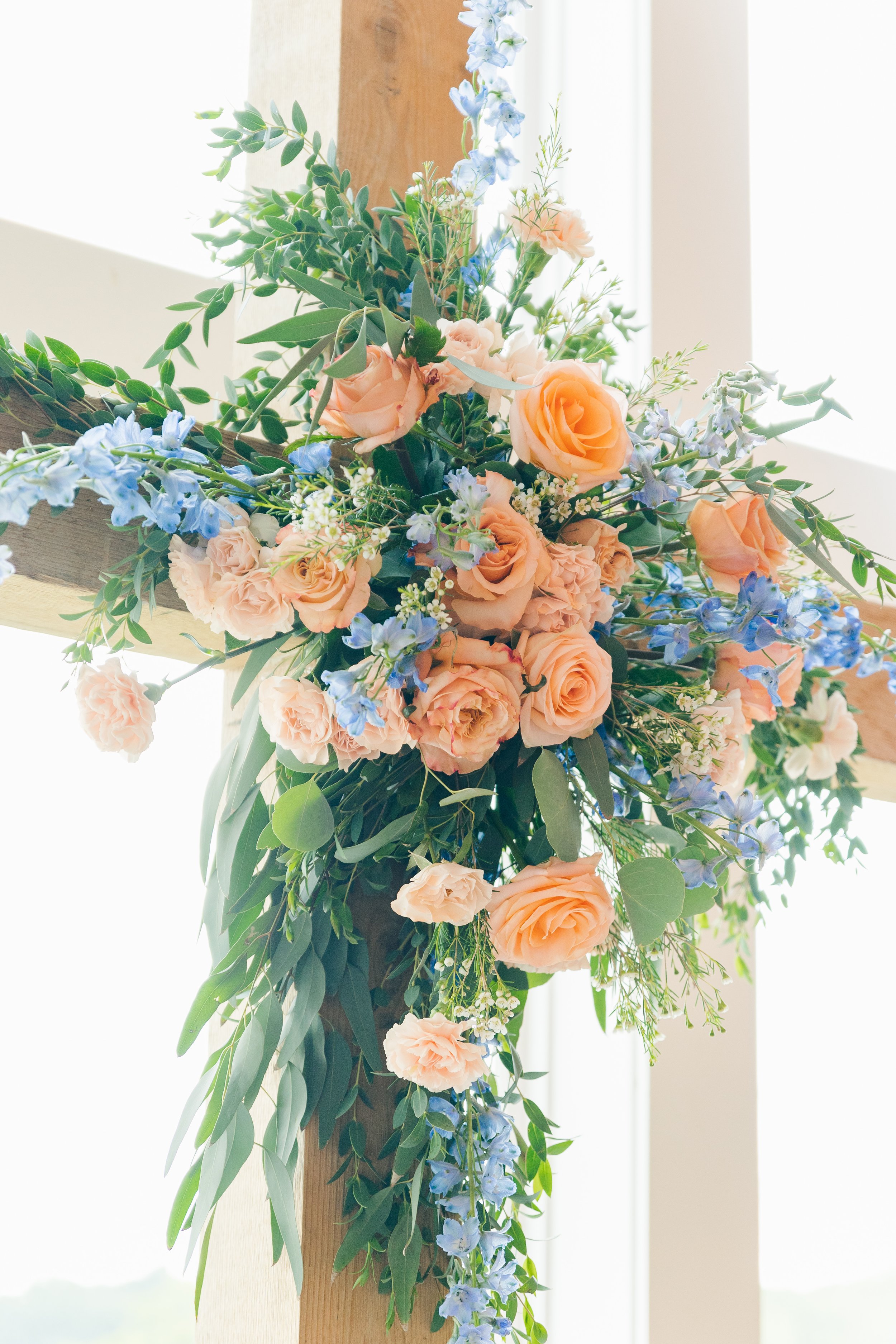floral cross for wedding altar indoor ceremony summer peach blue.jpg